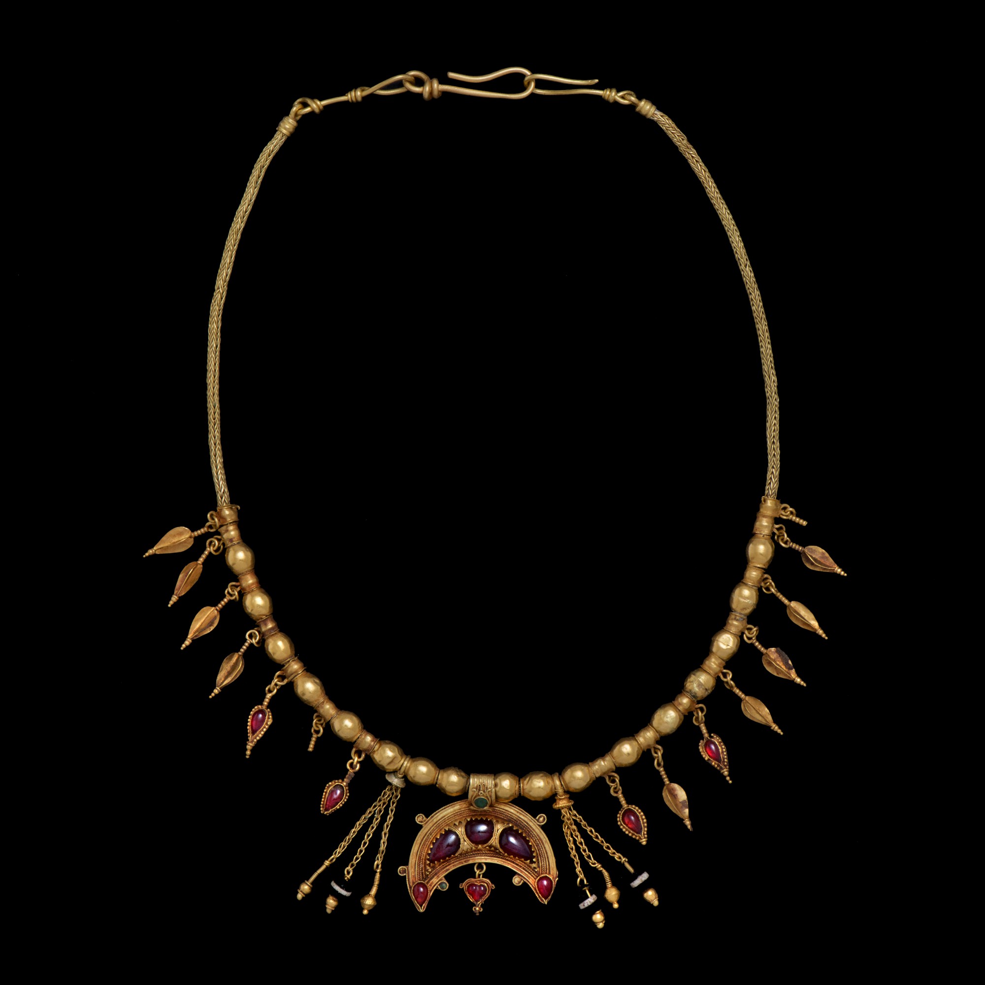 A Hellenistic Gold, Garnet and Green Glass Necklace, — A Hellenistic Gold, Garnet and Green Glass Necklace, circa 2nd/1st century B.C.