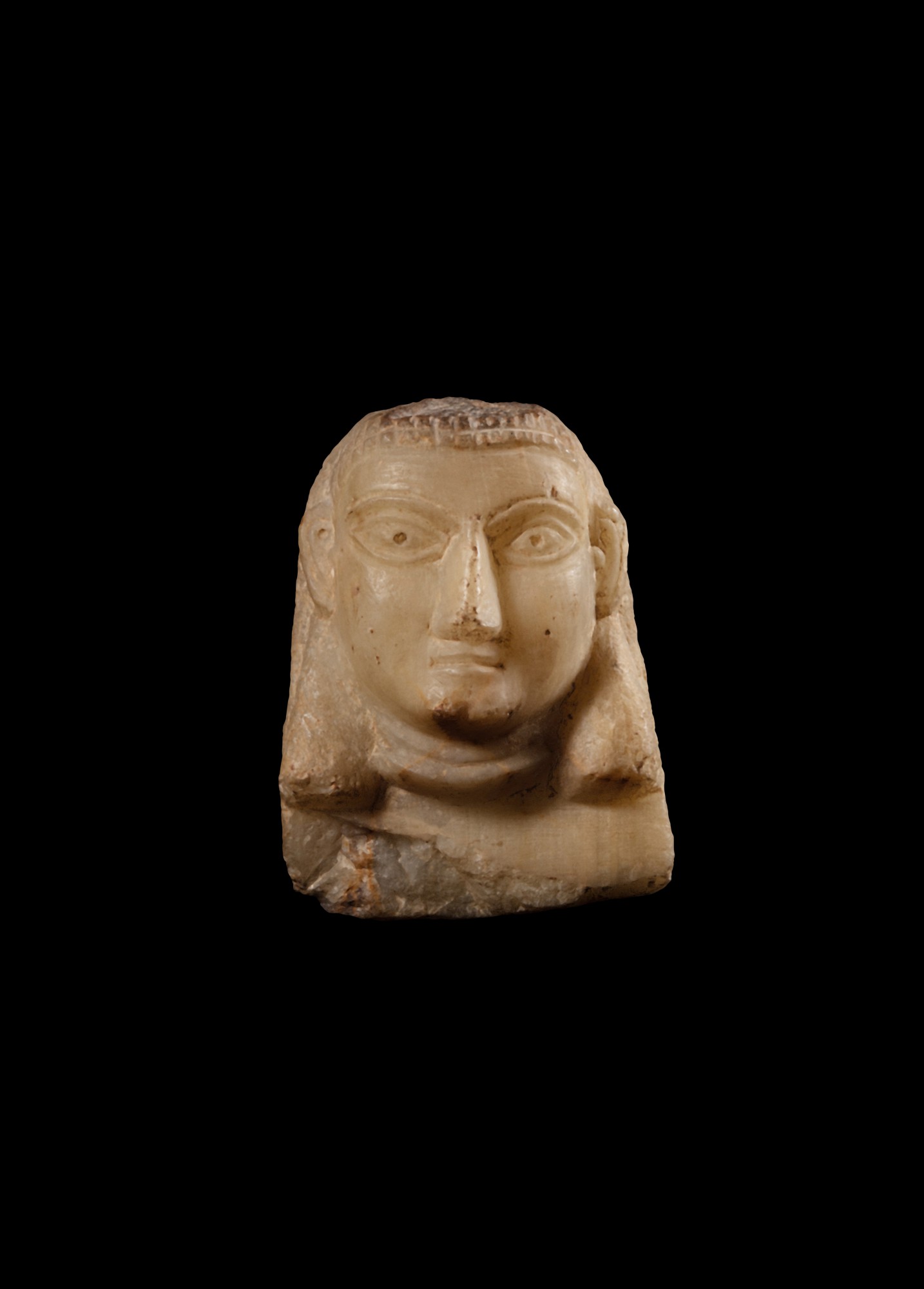 A South Arabian Alabaster Relief Head of a Woman, Qataban — A South Arabian Alabaster Relief Head of a Woman, Qataban, 3rd Century B.C./1st Century A.D.
