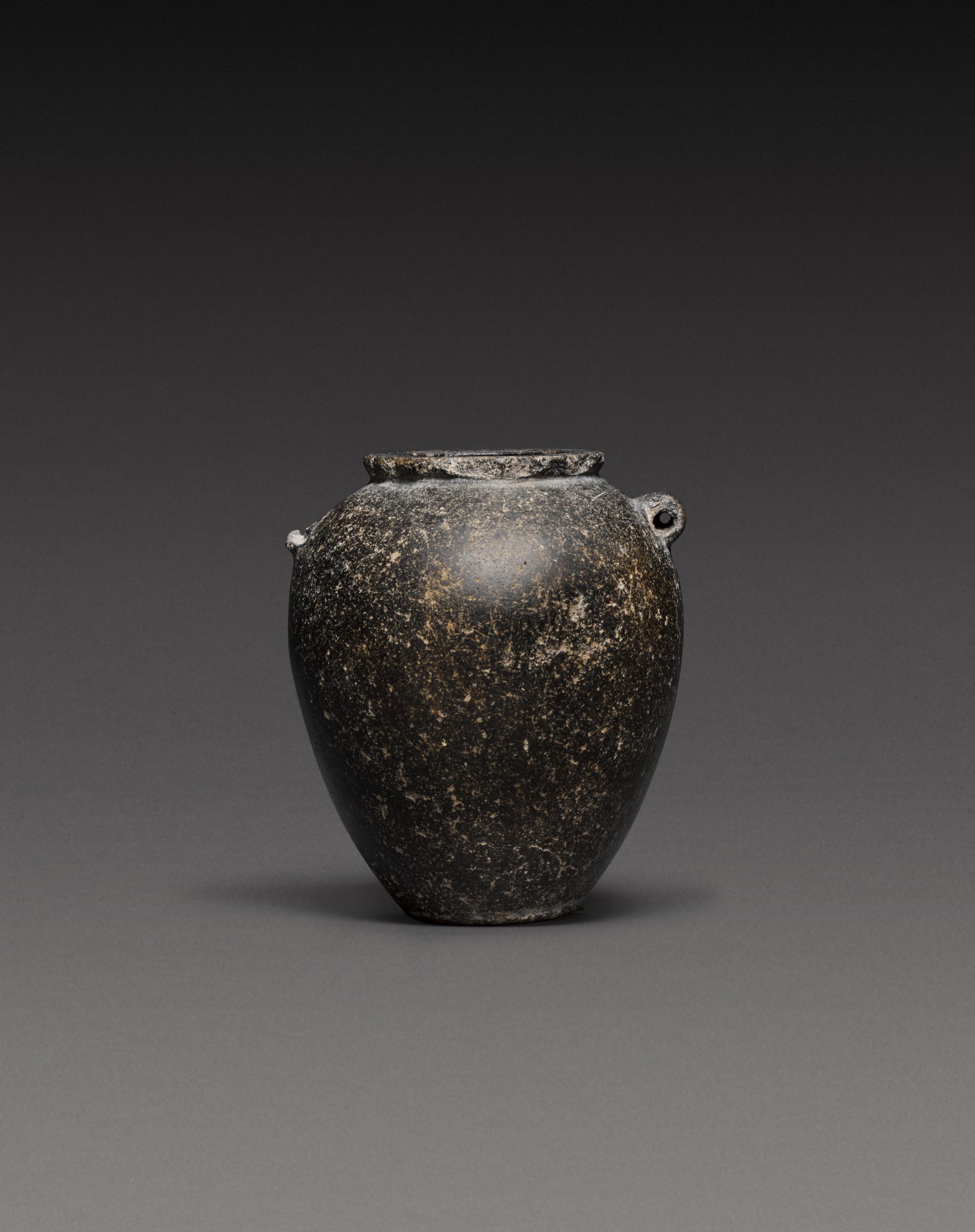 An Egyptian Basalt Jar, Predynastic Period (Naqada II)/1st Dynasty, circa 3500-2900 B.C.