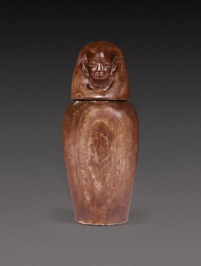 An Egyptian Banded Alabaster Canopic Jar