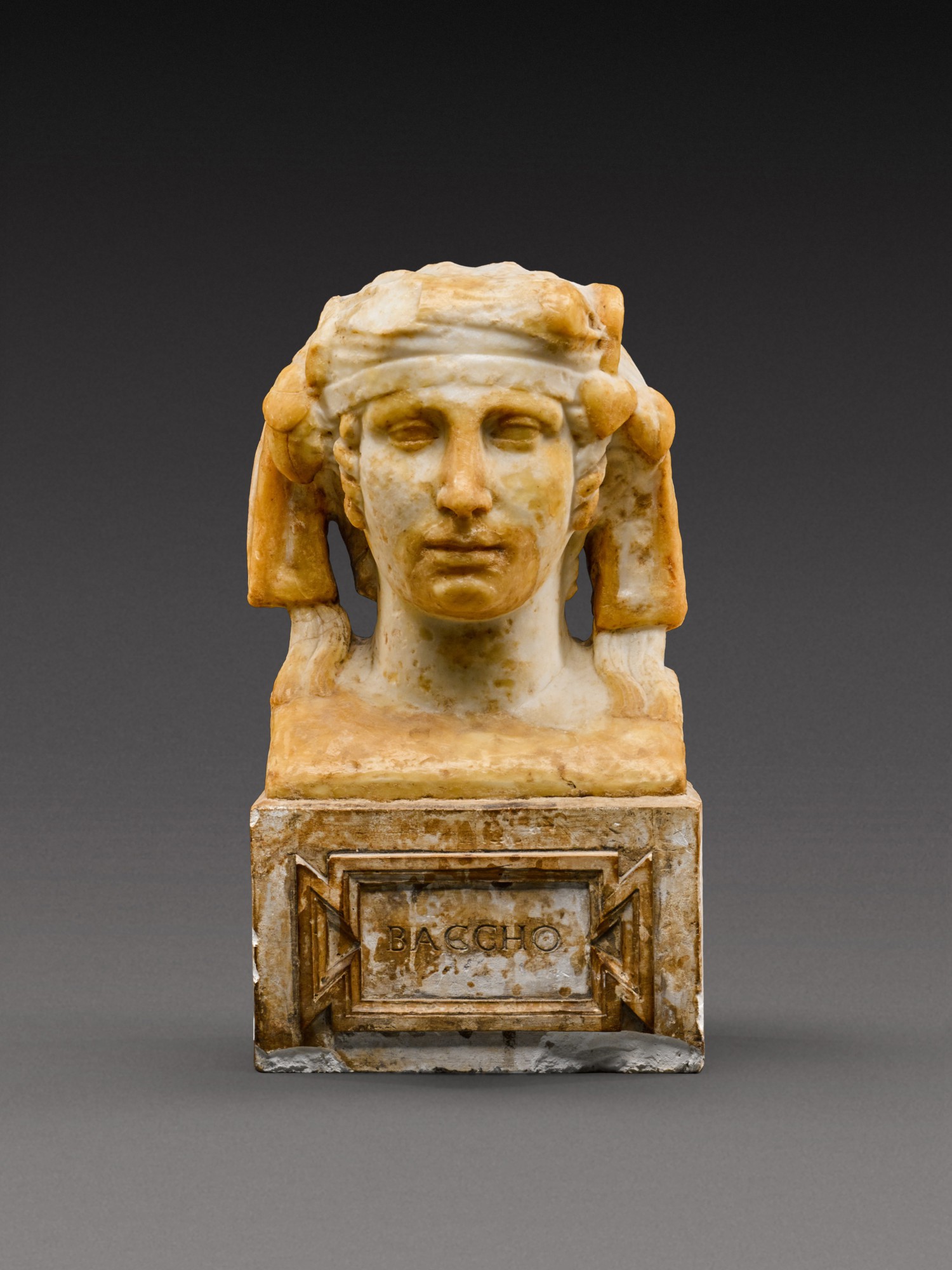 A Roman Marble Herm Bust of the Young Dionsyos — A Roman Marble Herm Bust of the Young Dionsyos, circa 2nd Century A.D.