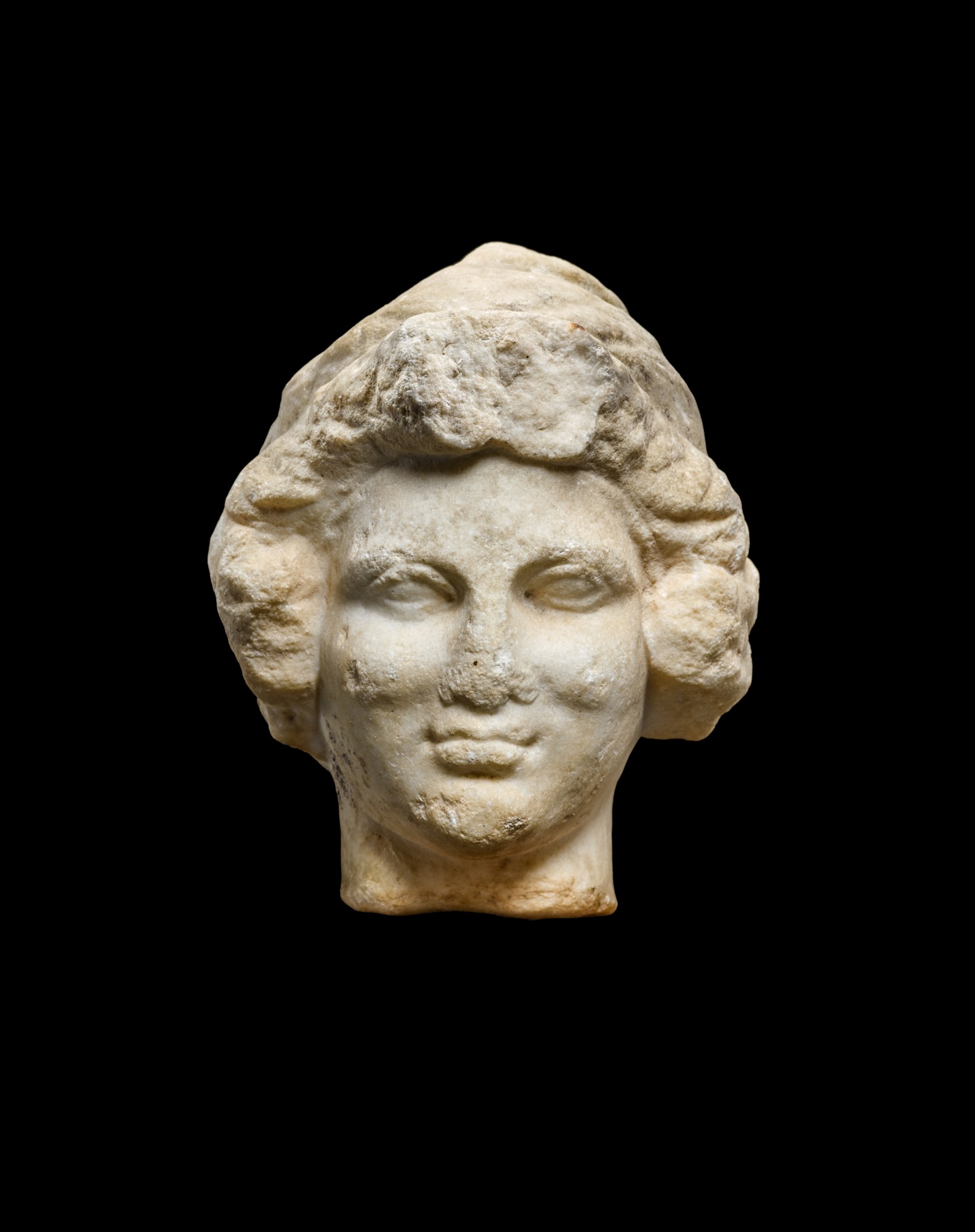 A Roman Marble Relief Head of a Child, probably Eastern Mediterranean — A Roman Marble Relief Head of a Child, probably Eastern Mediterranean, circa 2nd Century A.D.