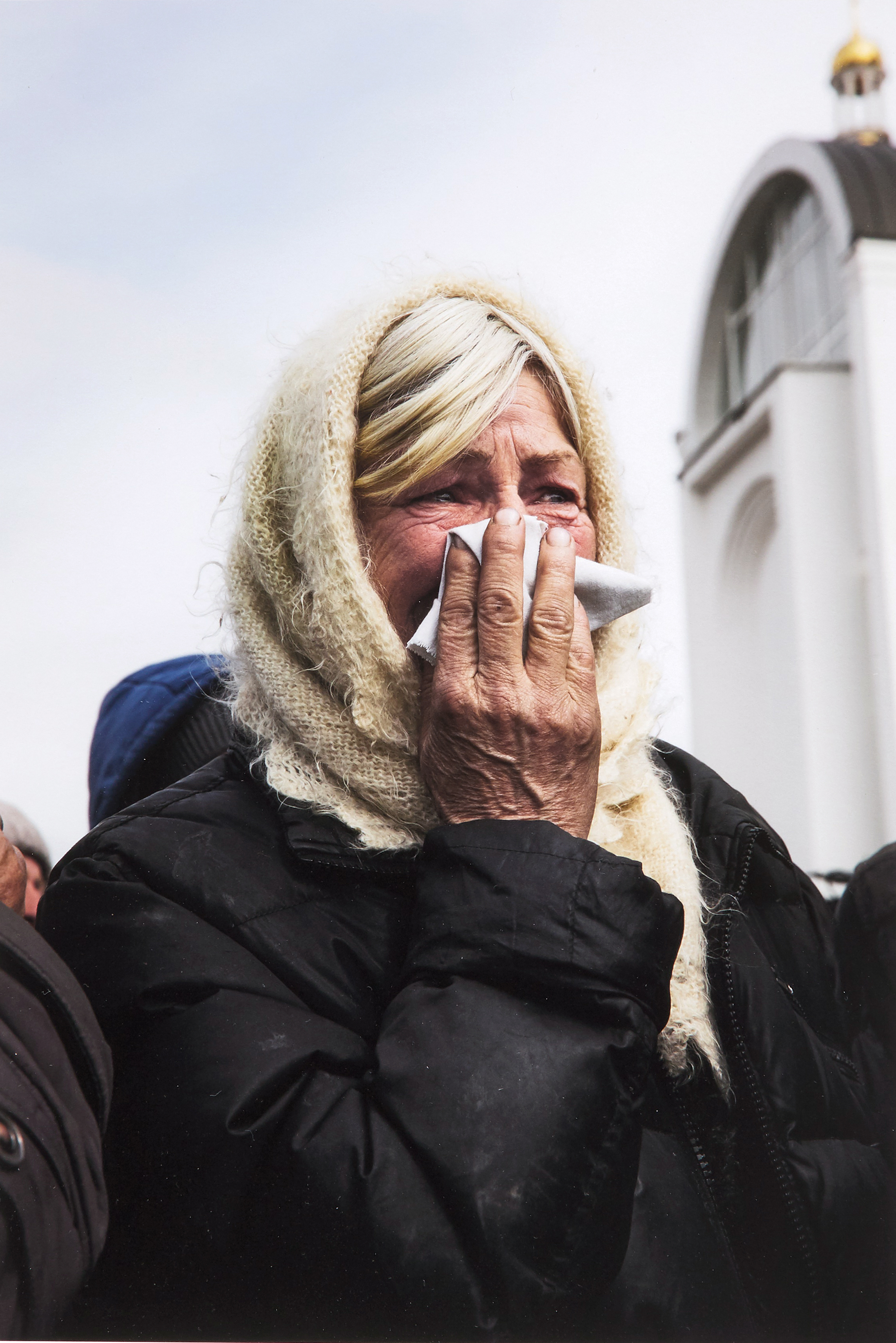 Unknown — A resident of Bucha Watches as Authorities Excavate a Mass Grave, Bucha, Kyiv Region, 8 April 2022