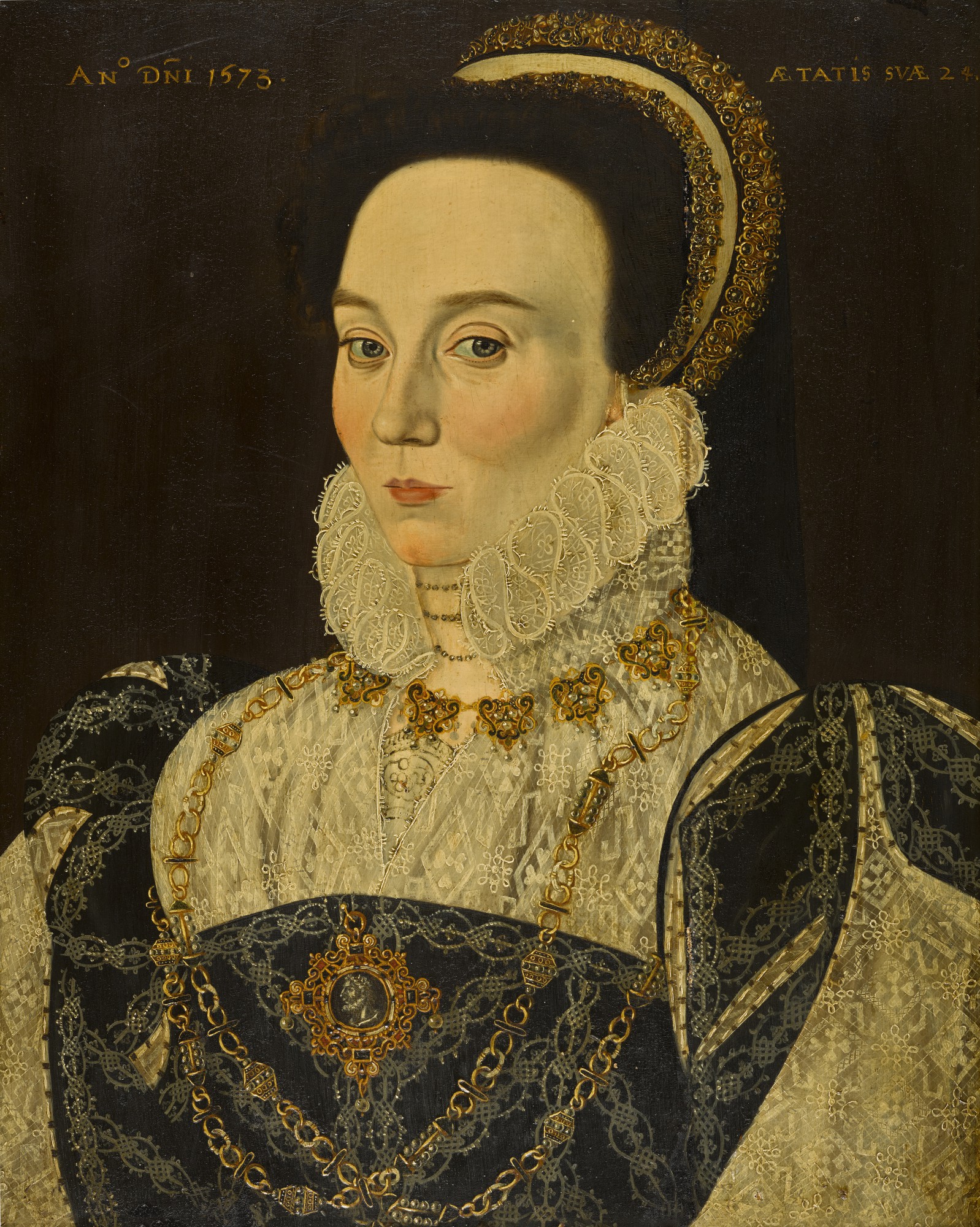 Circle of George Gower — Portrait of a lady, half-length, wearing an embroidered lace chemise with a dark overdress, a jewelled cap and fine golden pearl chain and pendant containing a cameo