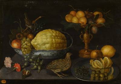 Still life of a citron, grapes, an apple and other fruits in a porcelain bowl with a sparrow, with plums and apricots in a gilt tazza and a sliced lemon, olives and capers on a salver, with hazelnuts, flowers and a quail, all upon a ledge