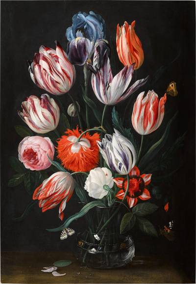 Still life of tulips, roses, poppy anemones and an iris in a glass vase