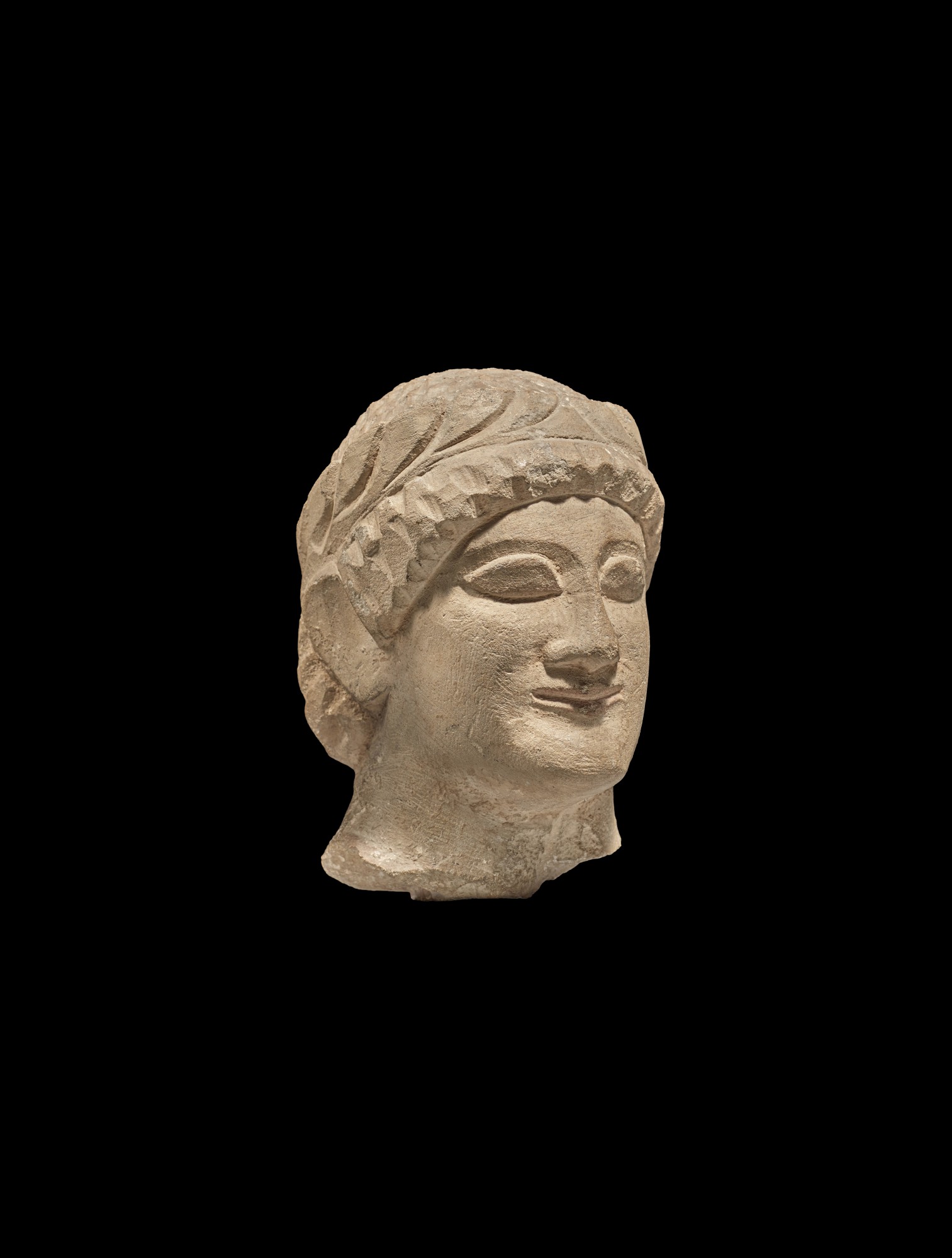 A Cypriot Limestone Head of a Youth — A Cypriot Limestone Head of a Youth, circa late 6th/early 5th Century B.C.