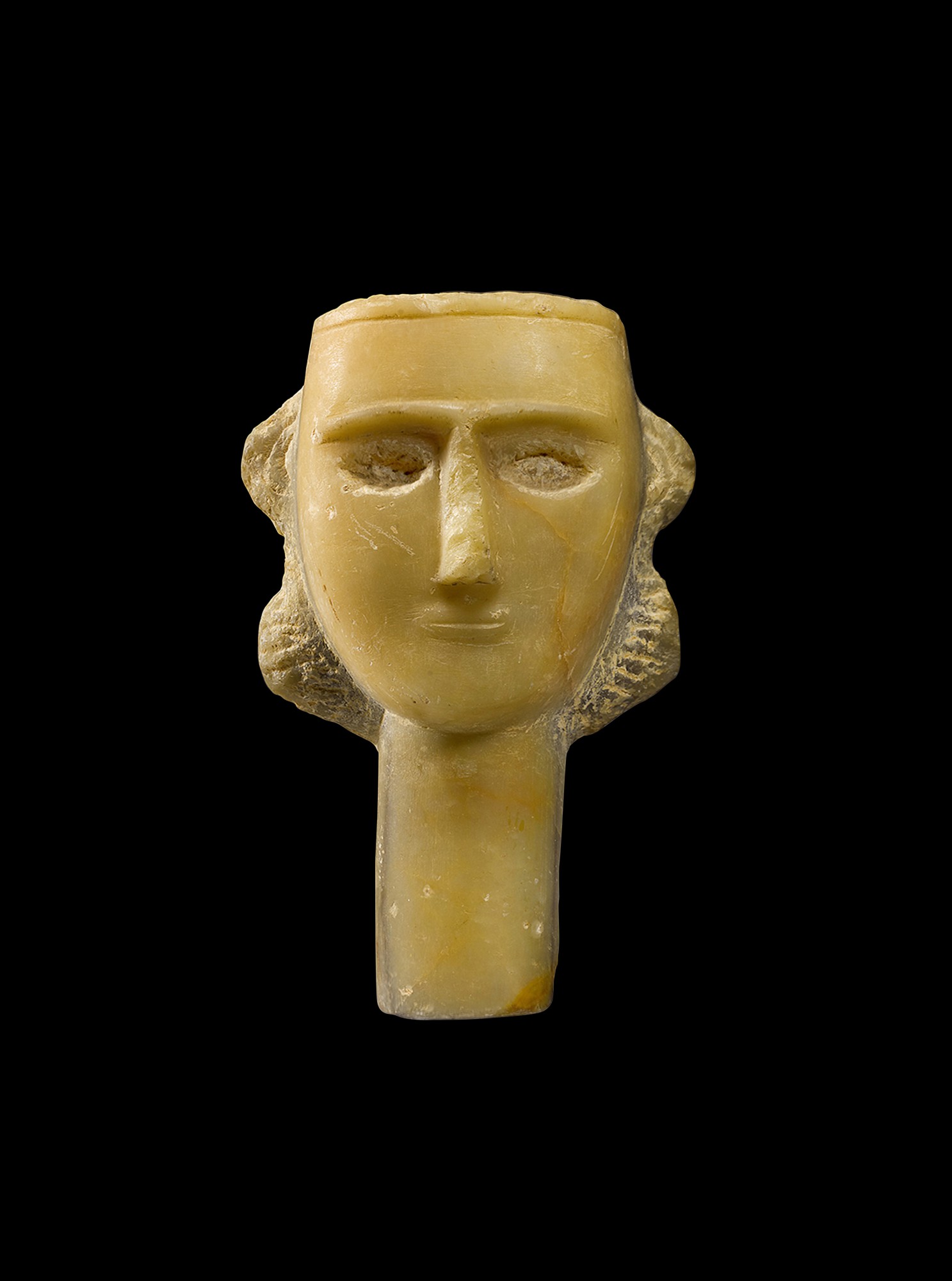 A South Arabian Alabaster Head of a Woman — A South Arabian Alabaster Head of a Woman, Qataban, 3rd Century B.C./1st Century A.D.