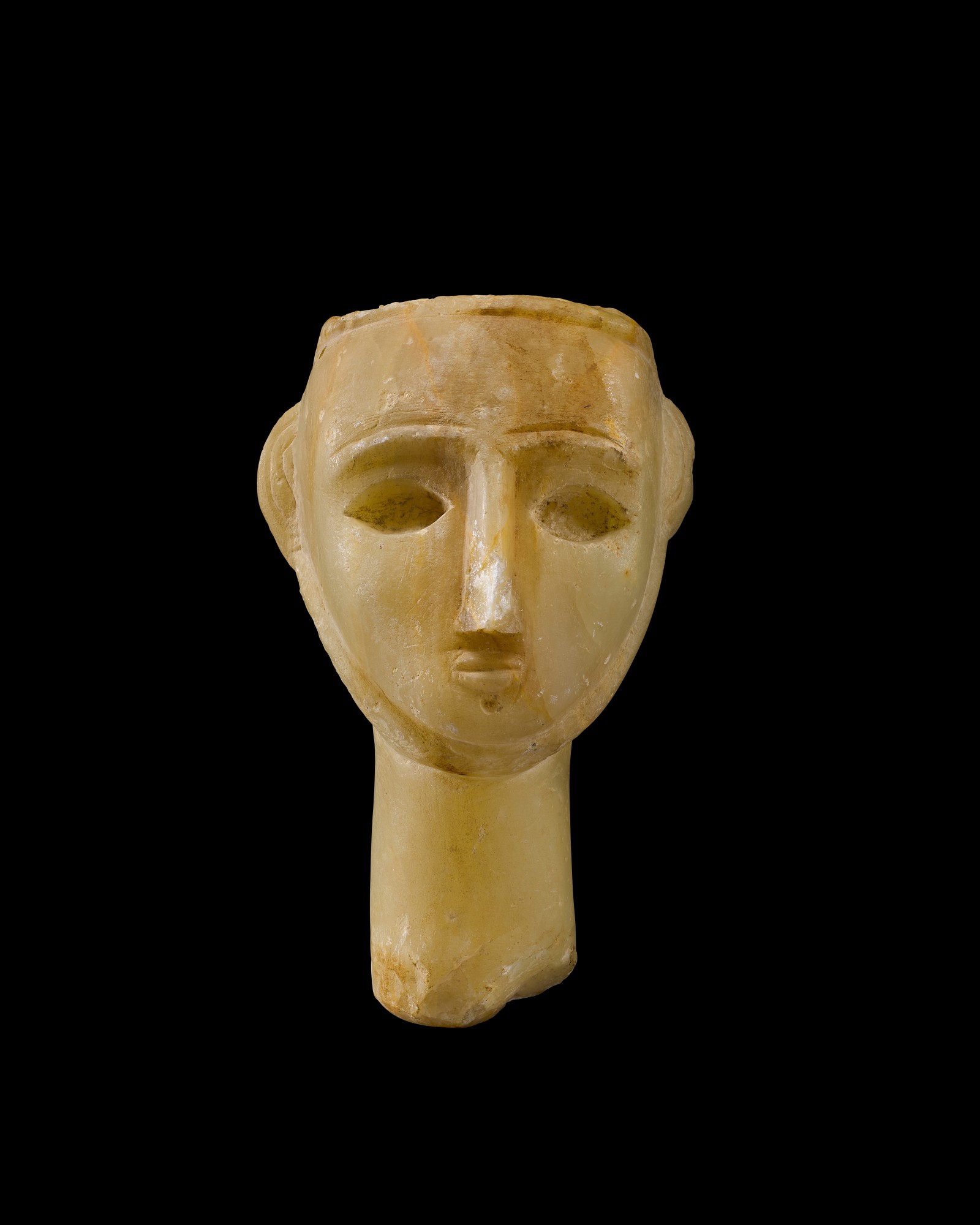 A South Arabian Alabaster Head of a Man — A South Arabian Alabaster Head of a Man, Qataban, 3rd Century B.C./1st Century A.D.