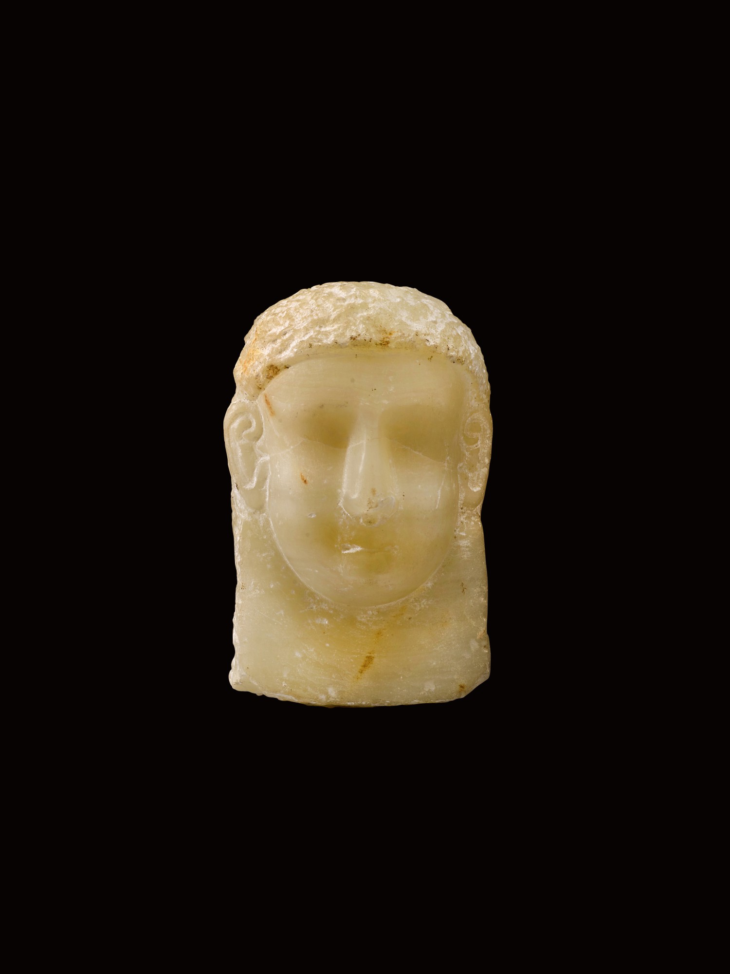 A South Arabian Alabaster Relief Head of a Man — A South Arabian Alabaster Relief Head of a Man, Qataban, 3rd Century B.C./1st Century A.D.
