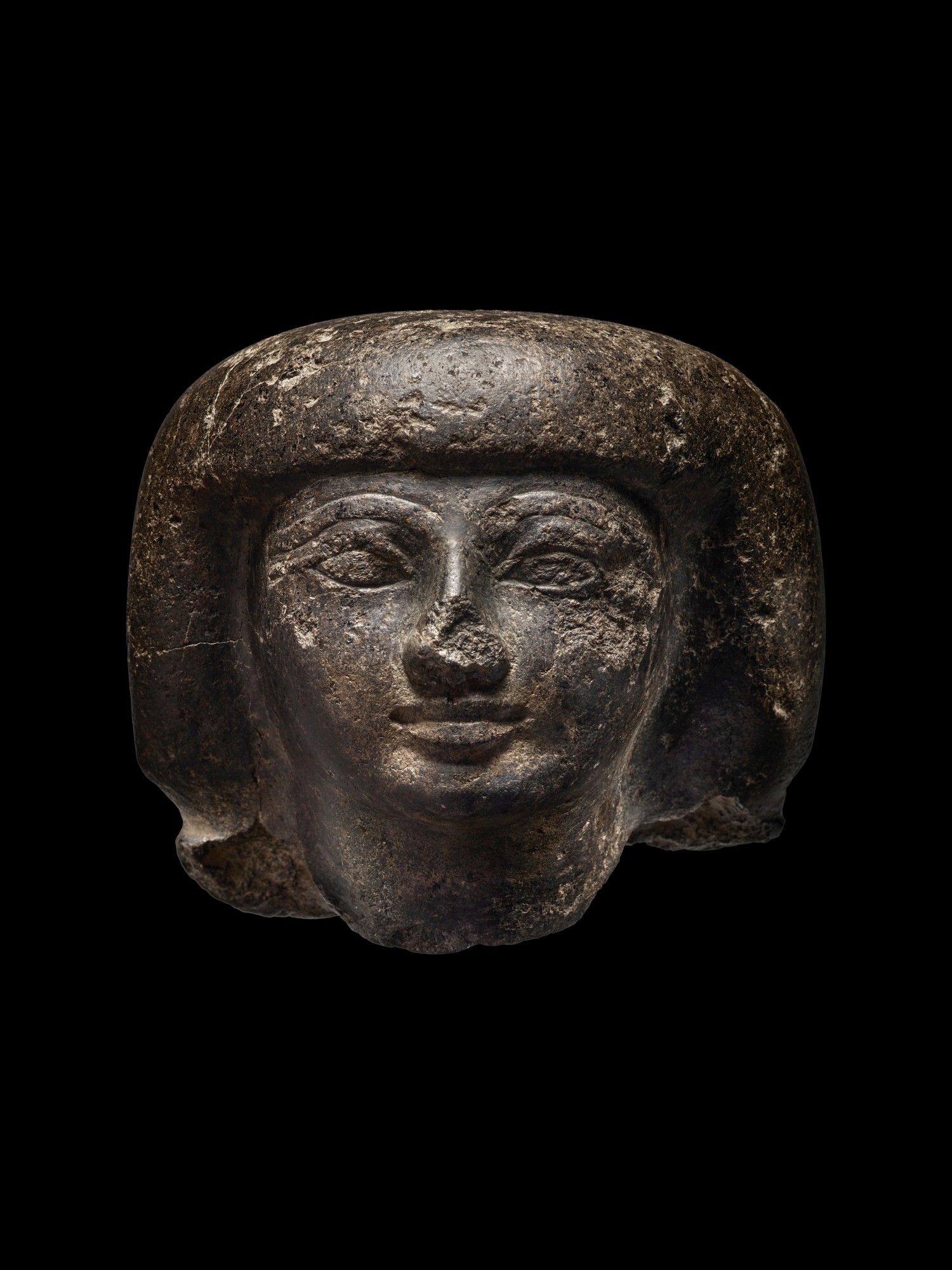 An Egyptian Granite head of a Man, 18th Dynasty, reign of Tuthmosis I/Hatshepsut, 1493-1458 B.C.