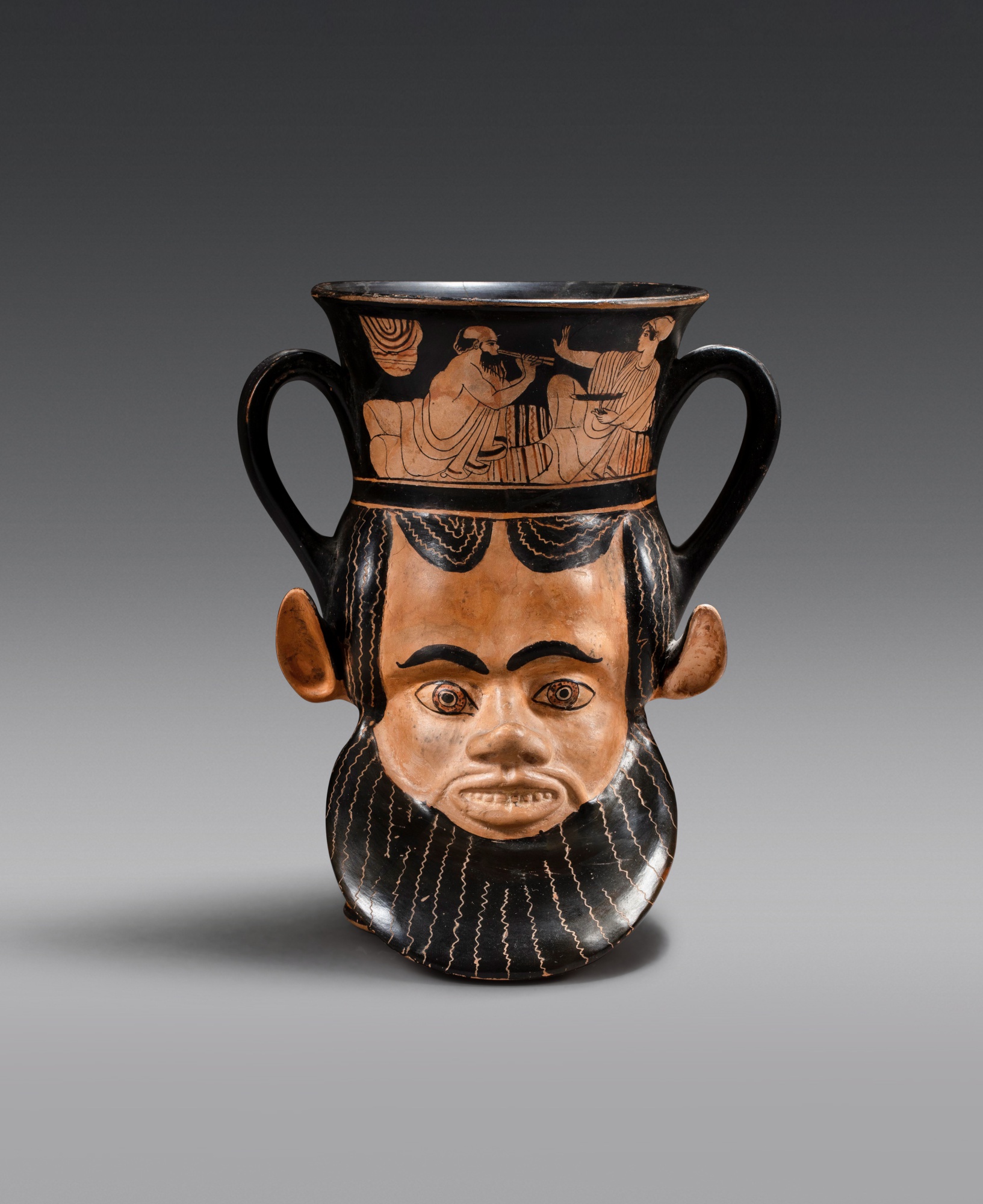 An Attic Red-Figured Janiform Kantharos — An Attic Red-Figured Janiform Kantharos, attributed to the Syriskos Painter, circa 480-470 B.C.