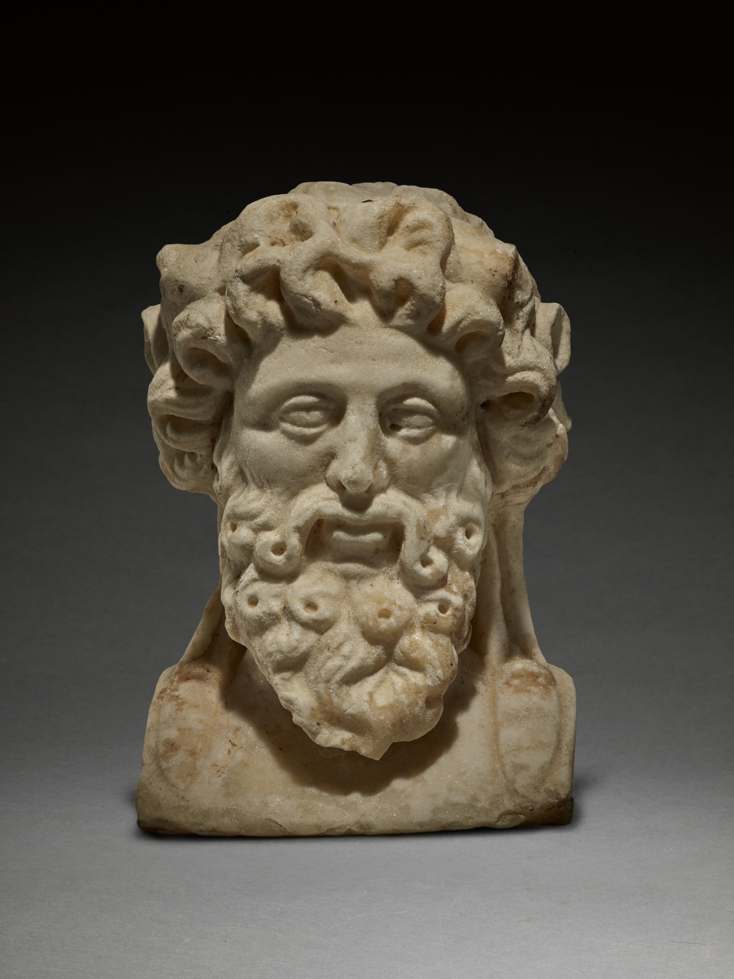 A Roman Marble Herm Head of Silenos — A Roman Marble Herm Head of Silenos, circa 1st Century A.D.