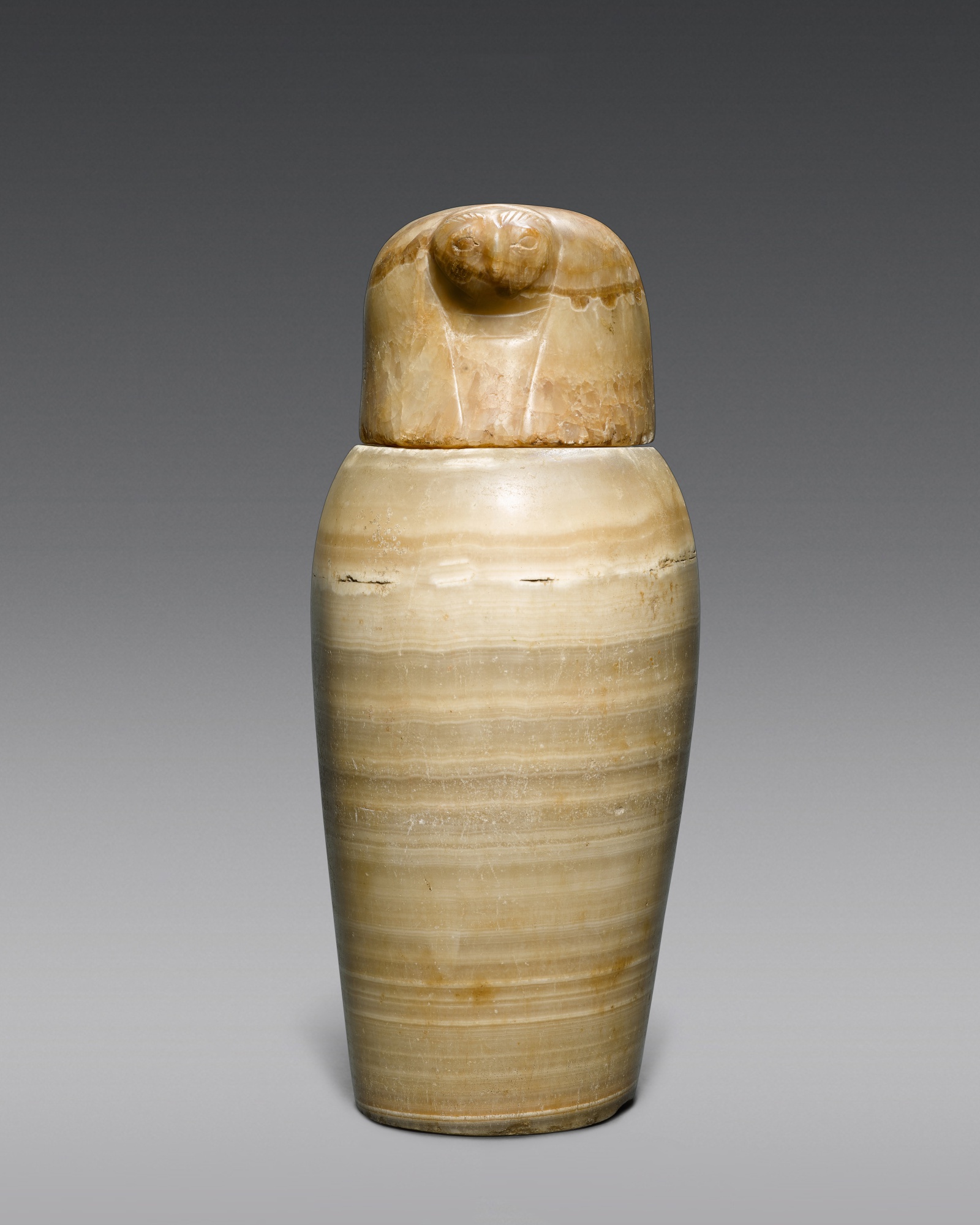 Another Property — An Egyptian Alabaster Canopic Jar and Lid, 26th/ 30th Dynasty, 664-342 B.C.