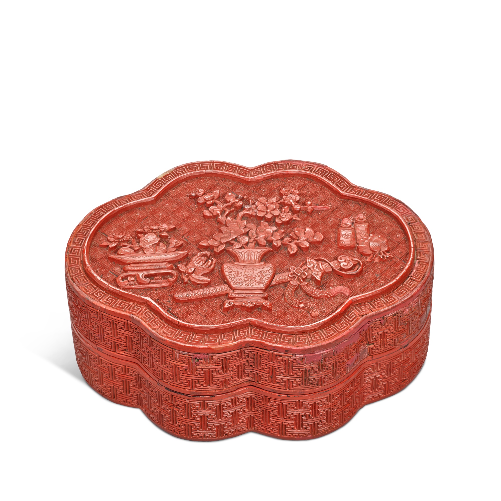 Unknown — A small carved cinnabar lobed lacquer box and cover, Qing dynasty, Qianlong period
