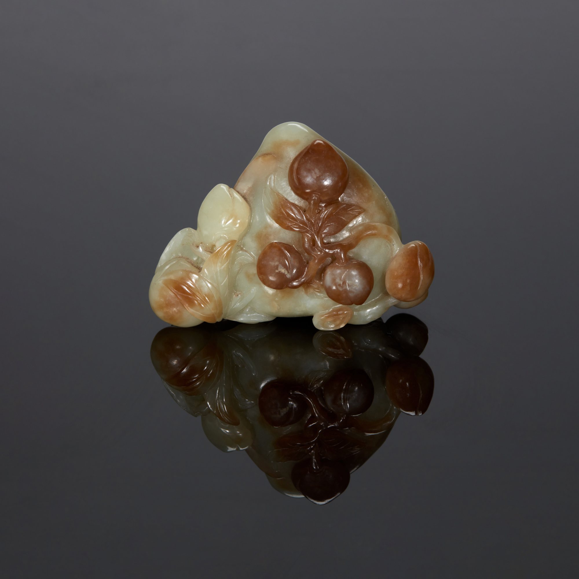 A pale celadon jade 'peach' group, — A pale celadon jade 'peach' group, Qing dynasty, Qianlong period 