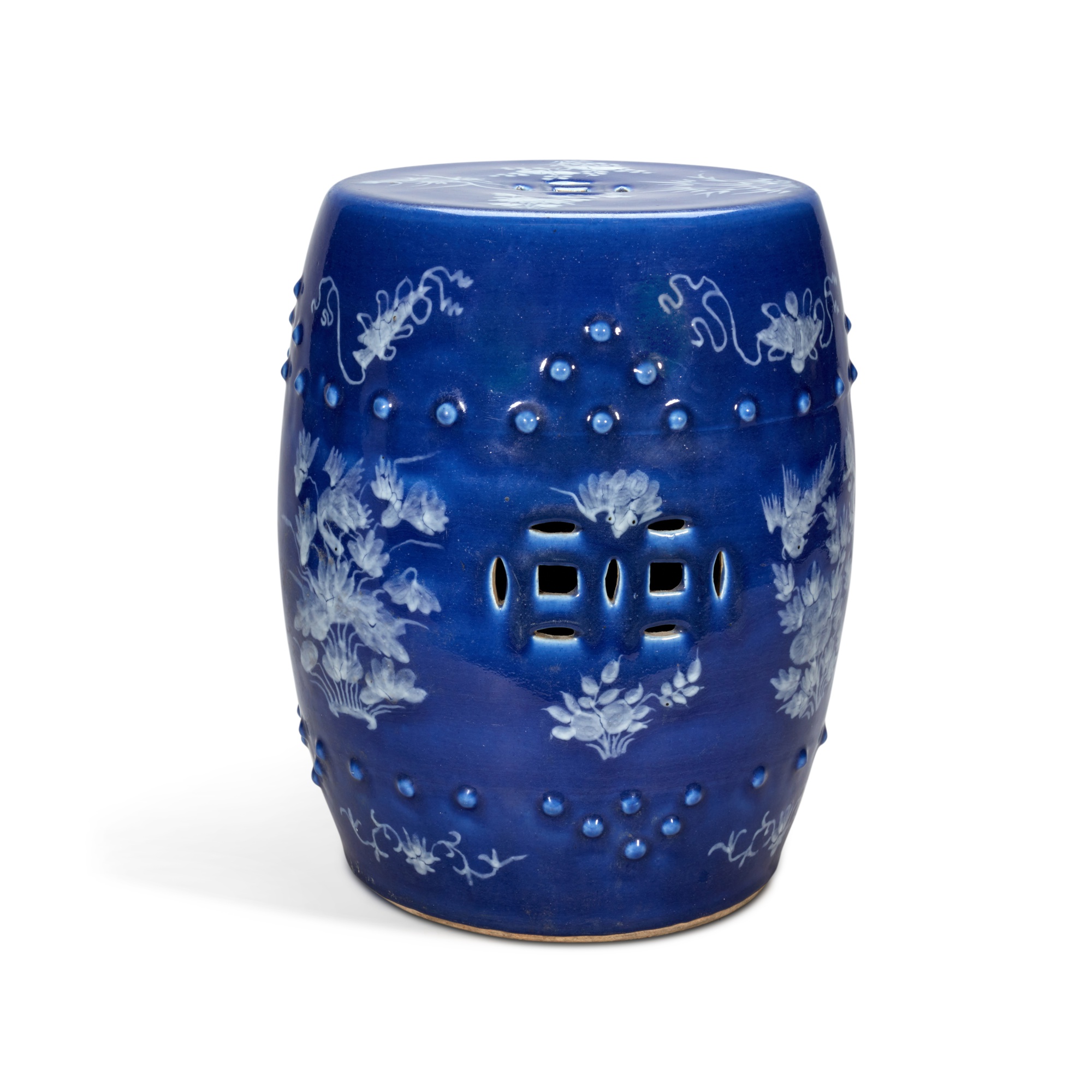 A slip-decorated blue ground barrel-form stool, — 十九 / 二十世紀 藍地堆白花卉紋坐墩