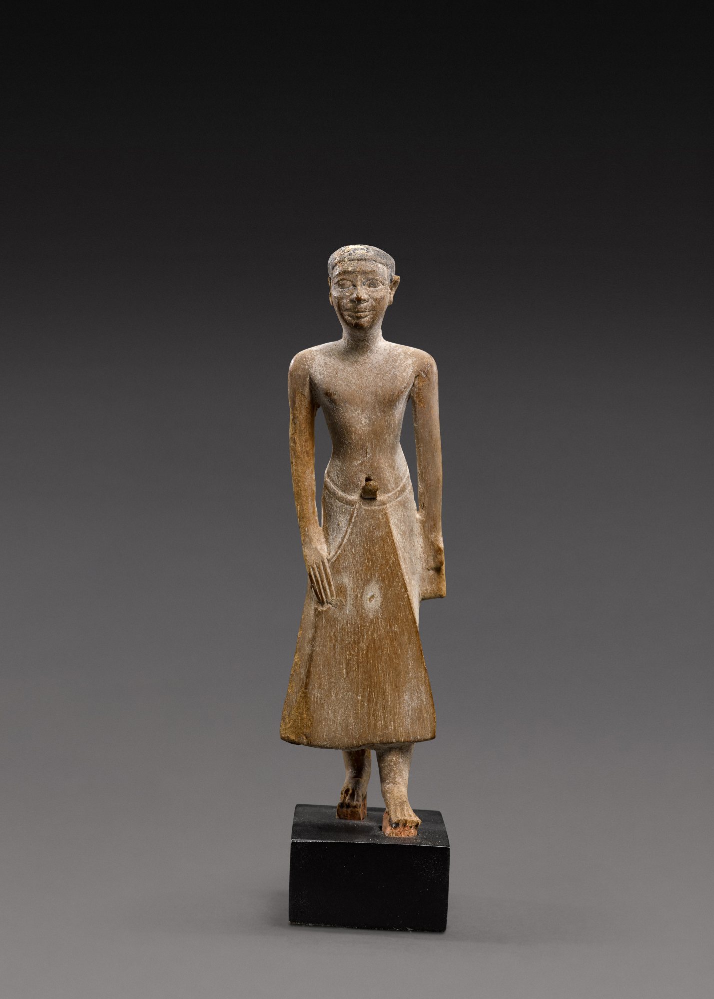 An Egyptian Wood Figure of a Man — An Egyptian Wood Figure of a Man, 6th Dynasty, reign of Pepi II, circa 2246-2152 B.C.