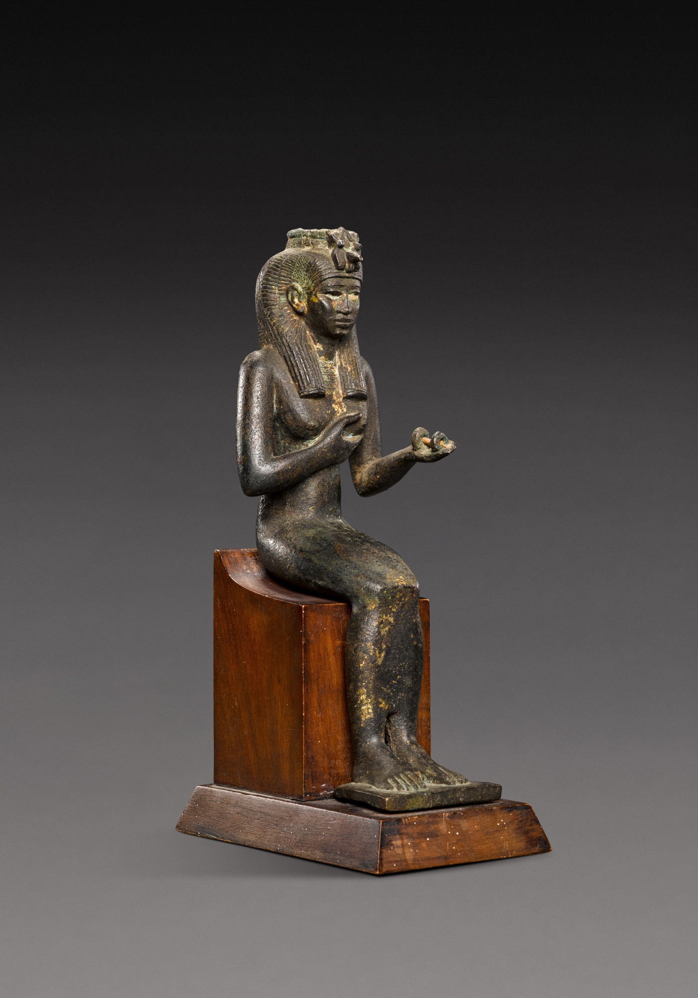 An Egyptian Bronze Figure of the Goddess Isis — An Egyptian Bronze Figure of the Goddess Isis, 21st/25th Dynasty, 1075-656 B.C.