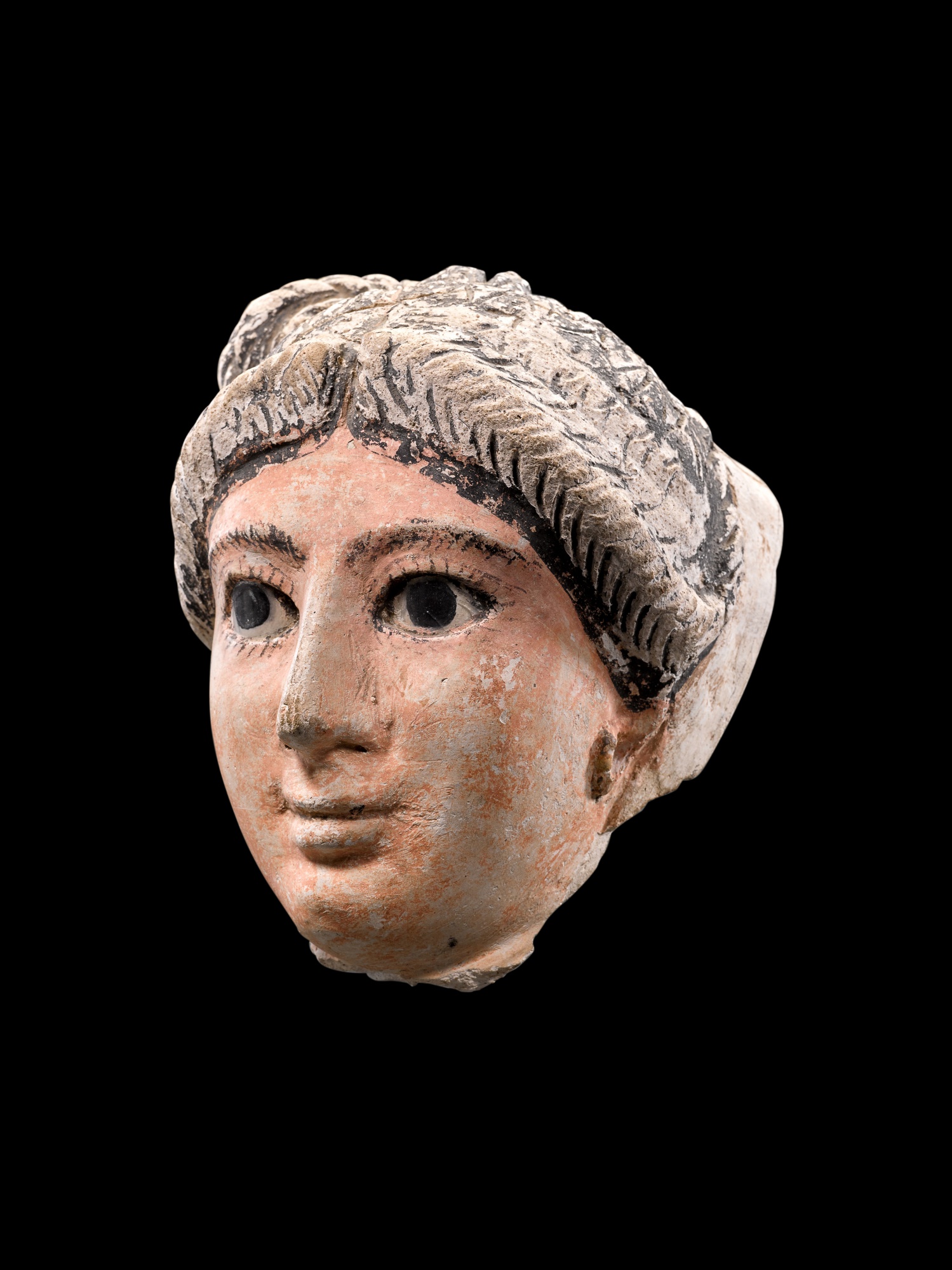 An Egyptian Stucco Mummy Mask of a Woman — An Egyptian Stucco Mummy Mask of a Woman, Roman Period, circa 2nd Century A.D. 