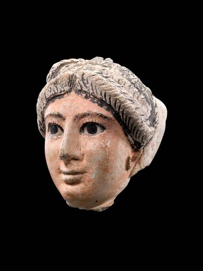 An Egyptian Stucco Mummy Mask of a Woman, Roman Period, circa 2nd Century A.D. 