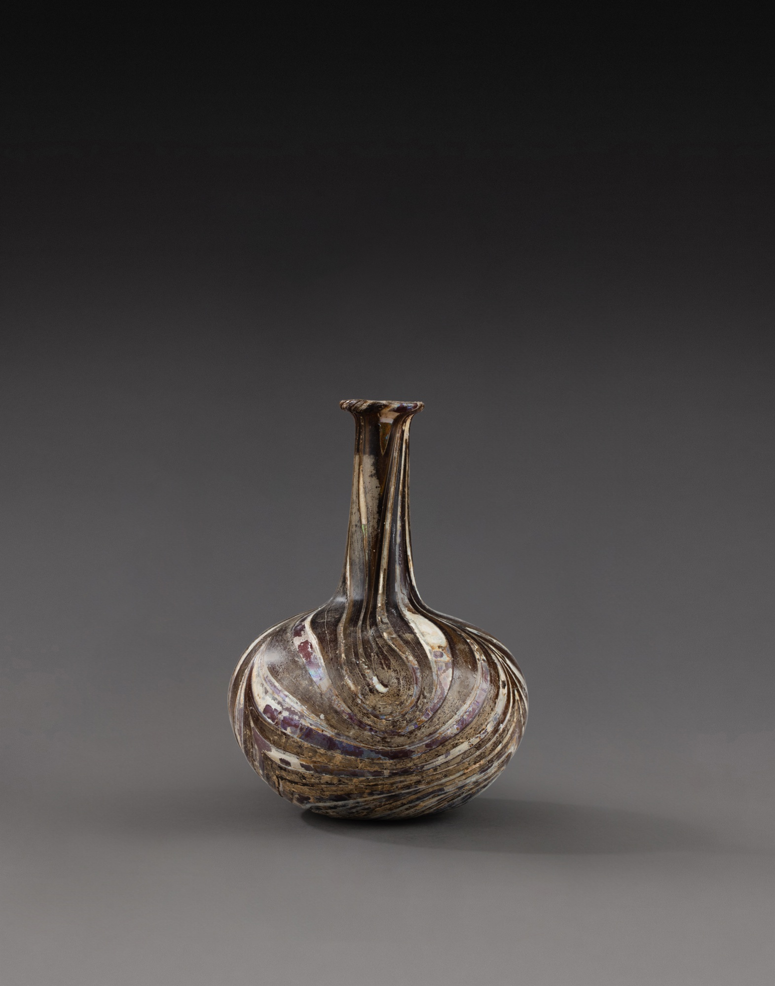 A Roman Marbled Aubergine Glass Bottle — A Roman Marbled Aubergine Glass Bottle, circa 1st Century A.D. 