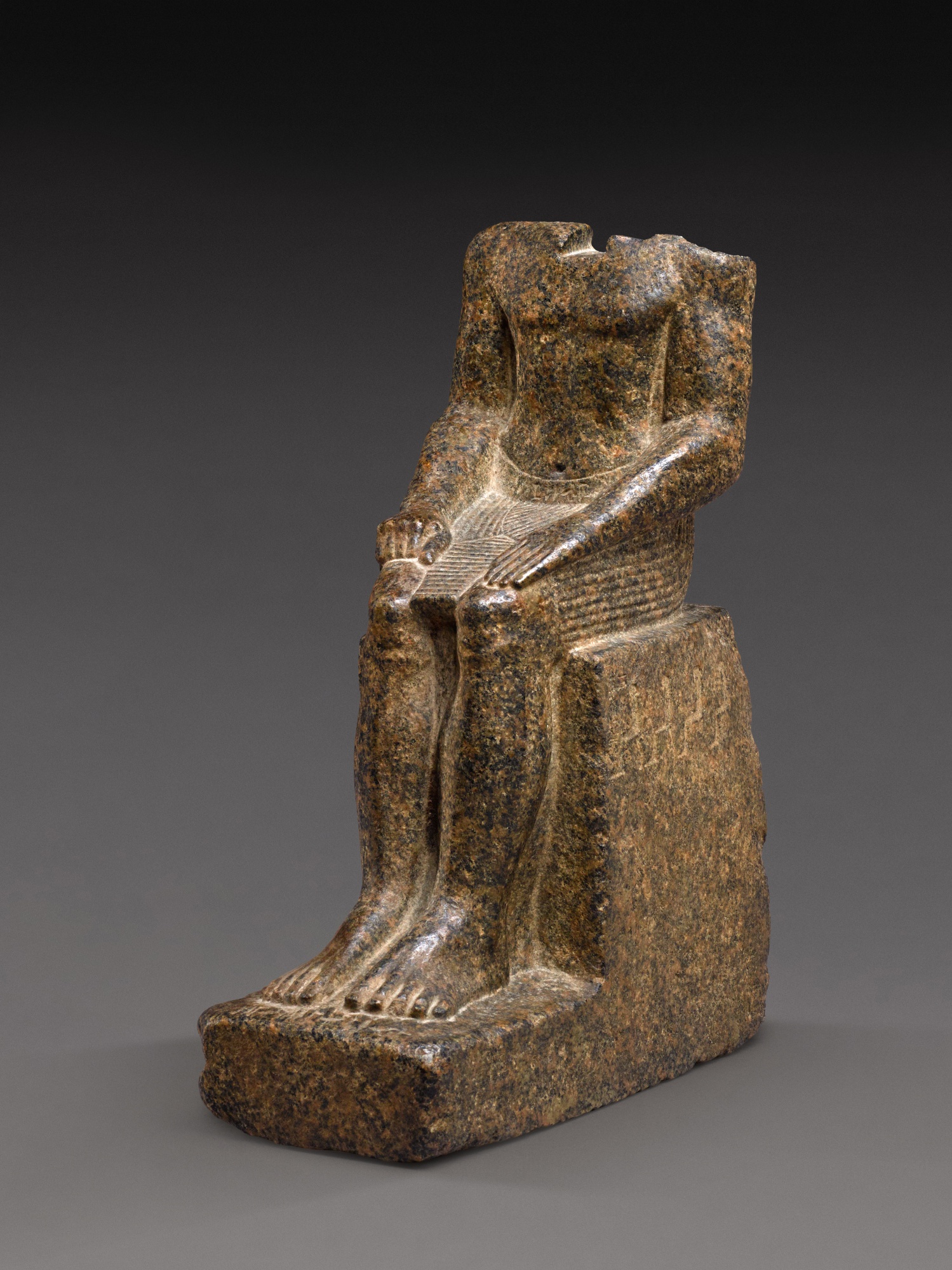 An Egyptian Aswan Granite Figure of a Man —  An Egyptian Aswan Granite Figure of a Man, 25th/early 26th Dynasty, circa 750-600 B.C.