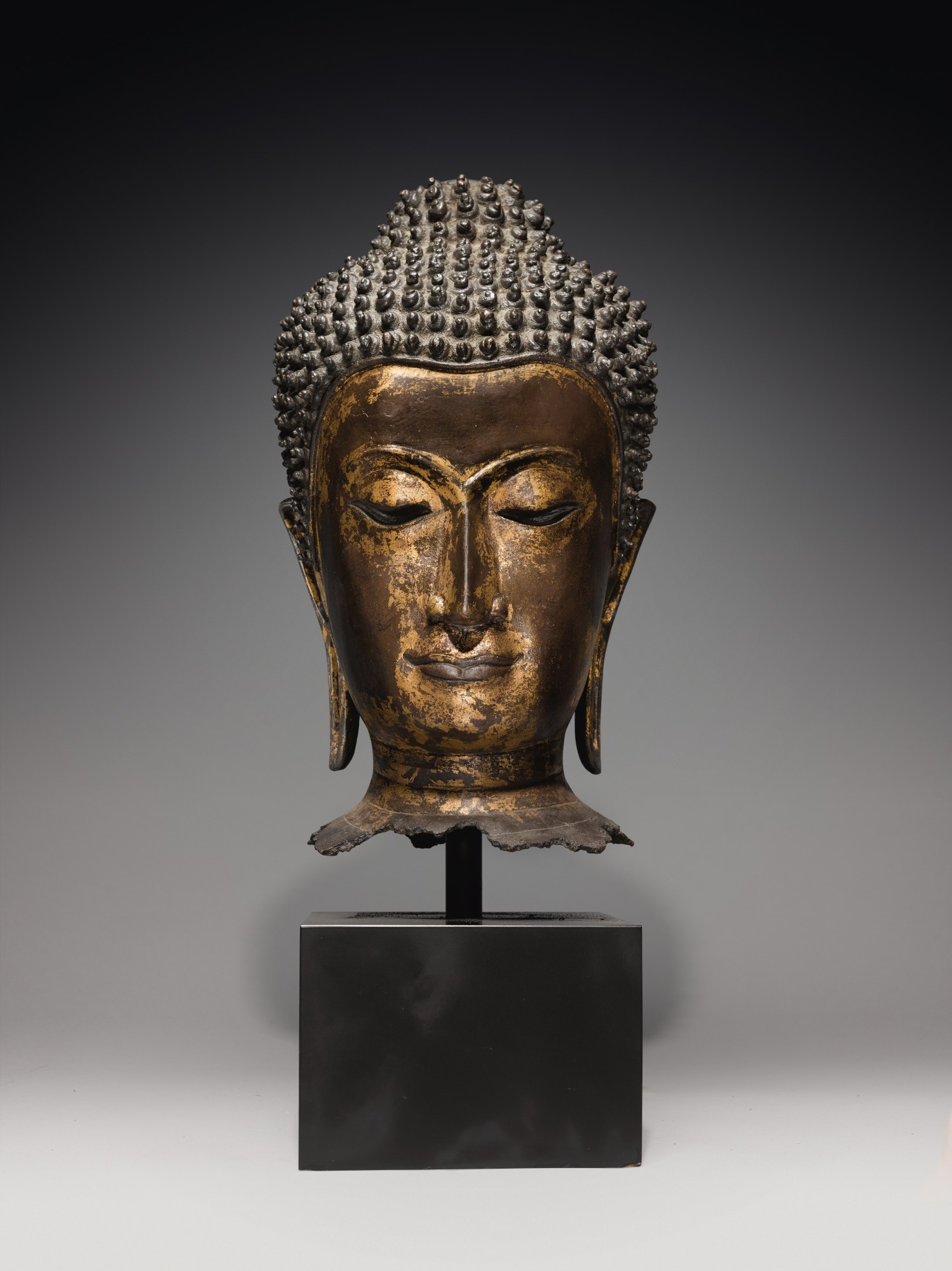 A Gilt Copper Alloy Head of Buddha — A Gilt Copper Alloy Head of Buddha, Ayutthaya Style, Thailand, circa 16th Century