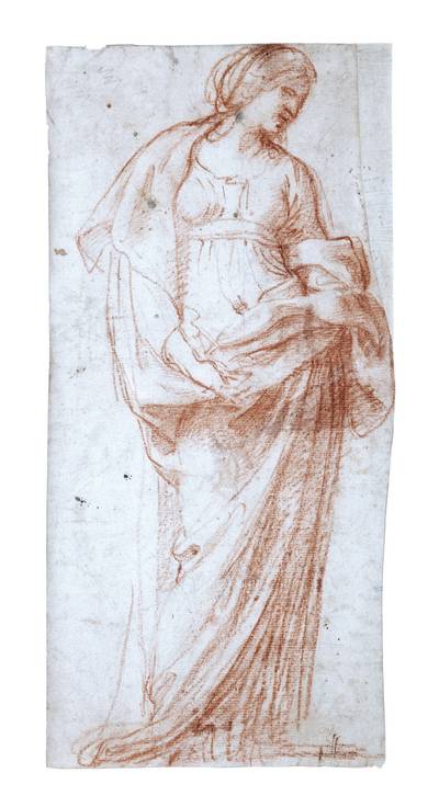 A woman, her hands clasped, looking down to the right