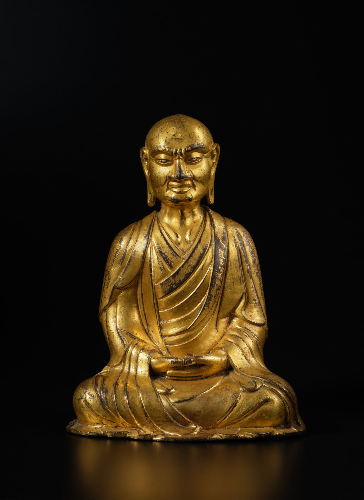 A gilt-bronze figure of Kasyapa — 遼 銅鎏金迦葉尊者坐像