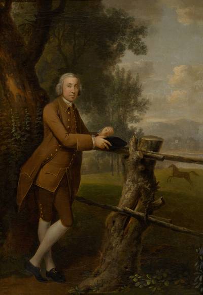 Portrait of a gentleman in a brown suit, full-length, with a horse in the field beyond
