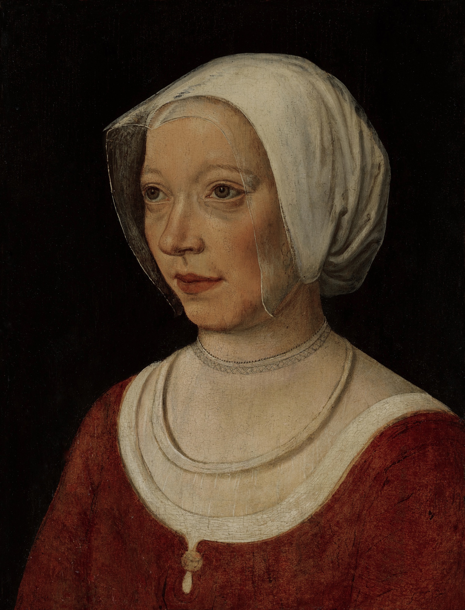 French School, circa 1520 — Portrait of a woman wearing a red dress, bust-length