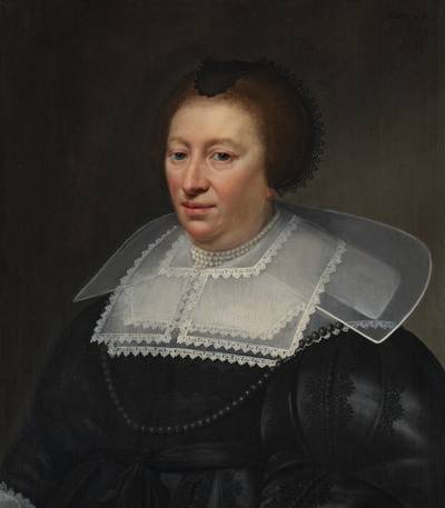 Portrait of a woman, aged 55, wearing a black dress, pearl necklace, and layered lace collar