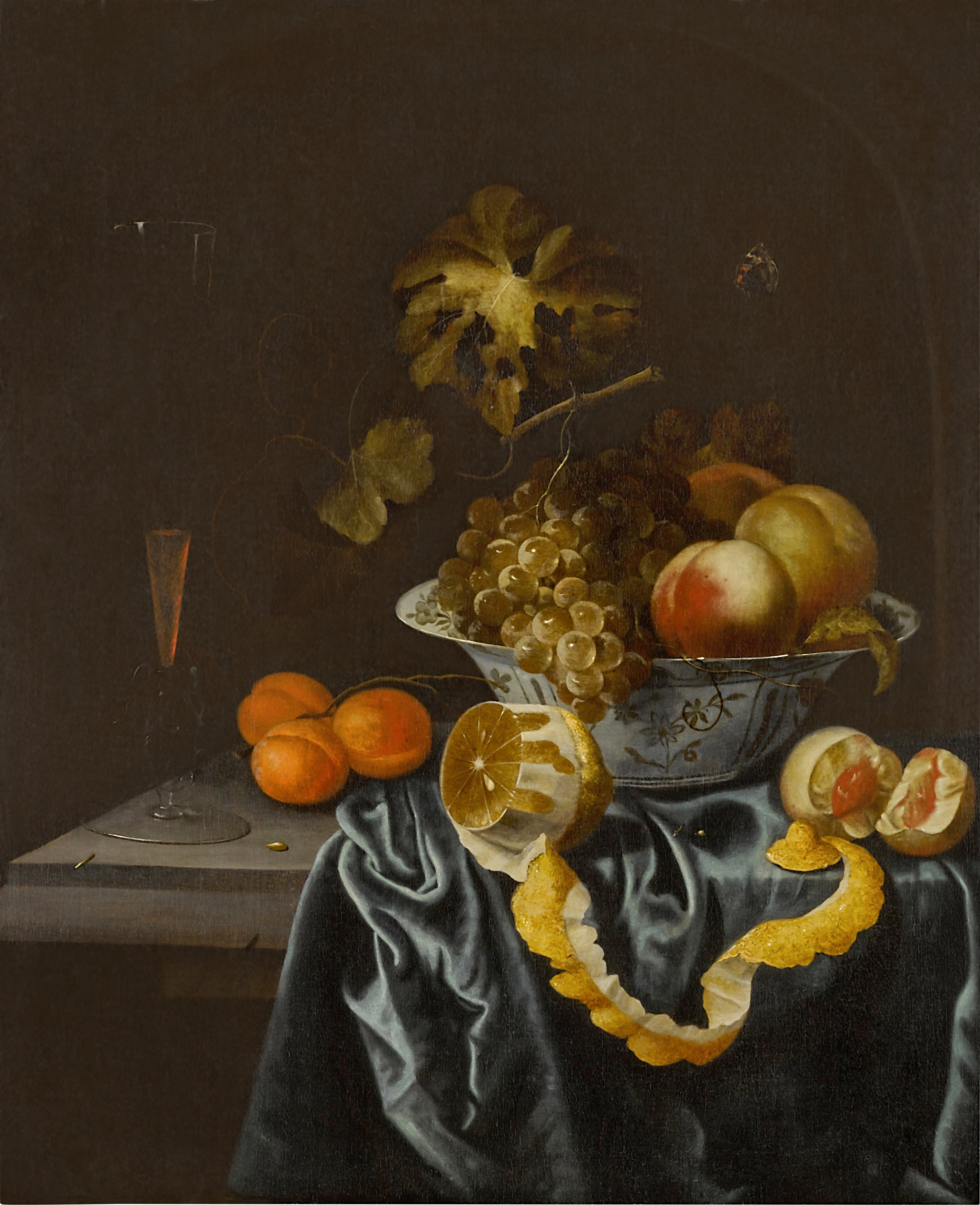 Unknown — Still life of a porcelain bowl with peaches and grapes, a peeled lemon, apricot, and a façon de Venise wine glass on a partially draped stone ledge