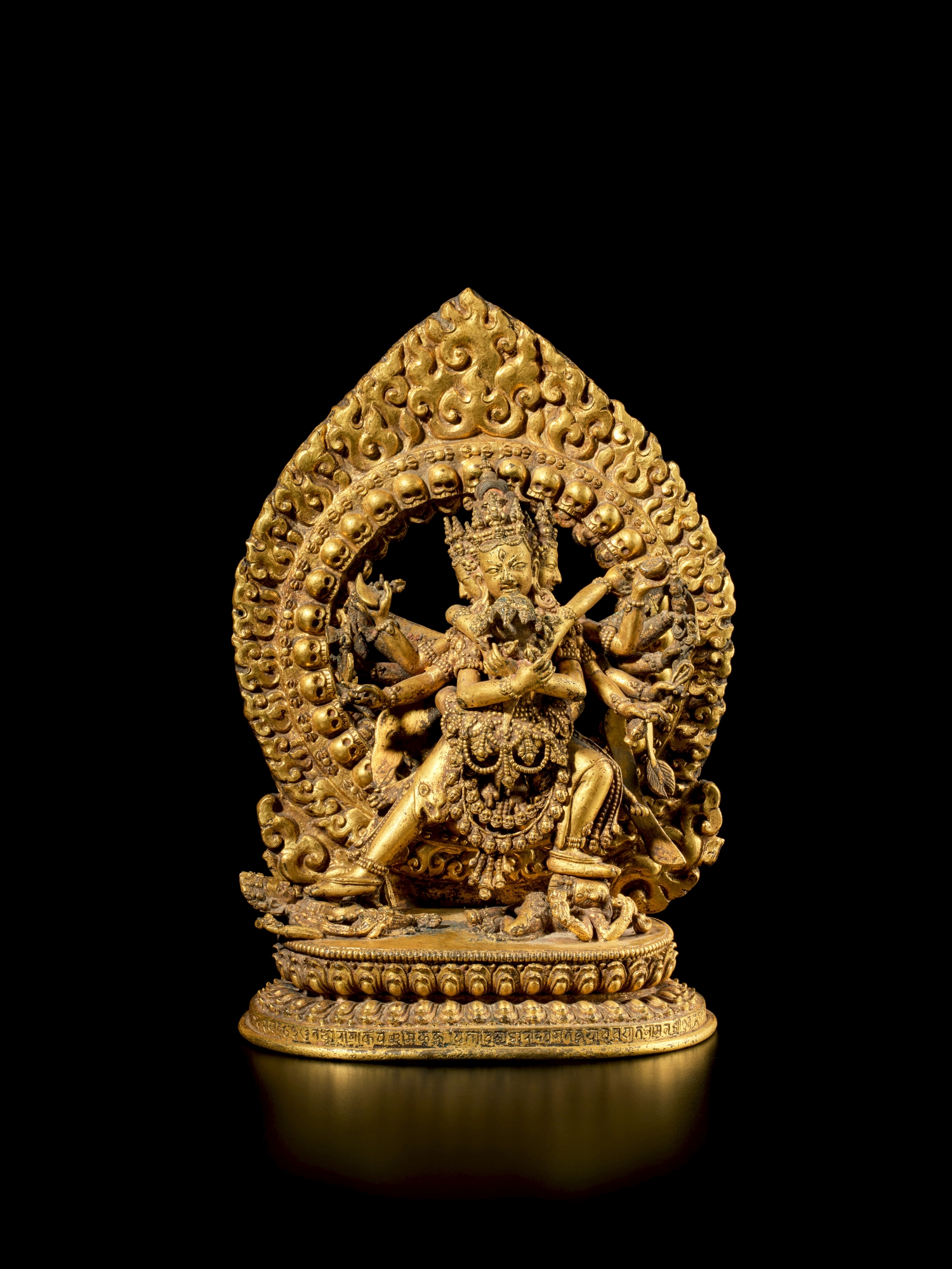An inscribed gilt-copper alloy figure of Chakrasamvara and Vajravarahi —  An inscribed gilt-copper alloy figure of Chakrasamvara and Vajravarahi, Nepal, dated 1715-16