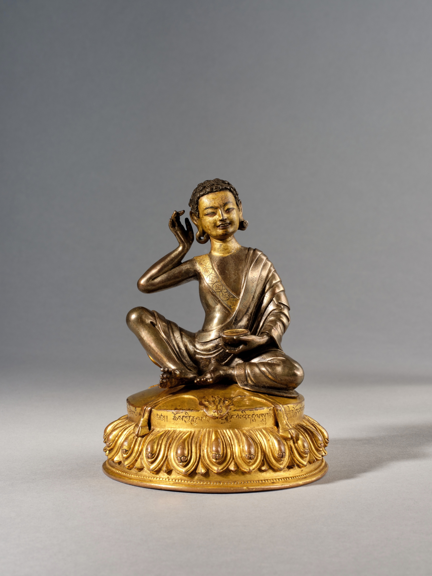 The Nyingjei Lam parcel-gilt silver and gilt-copper figure of Milarepa — The Nyingjei Lam parcel-gilt silver and gilt-copper figure of Milarepa, Tibet, 15th century