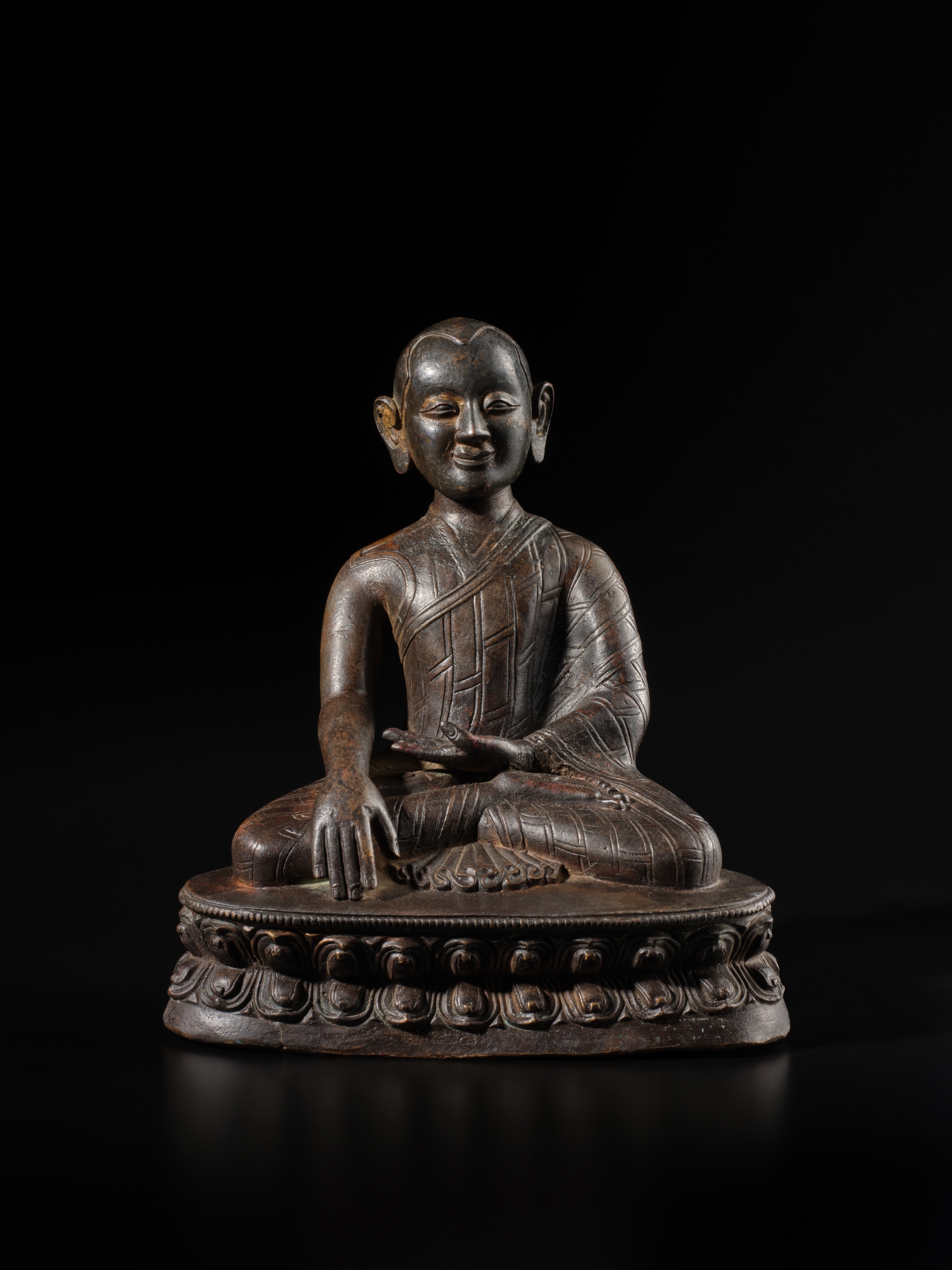 A large copper alloy figure of a lama — A large copper alloy figure of a lama, Tibet, circa 14th century