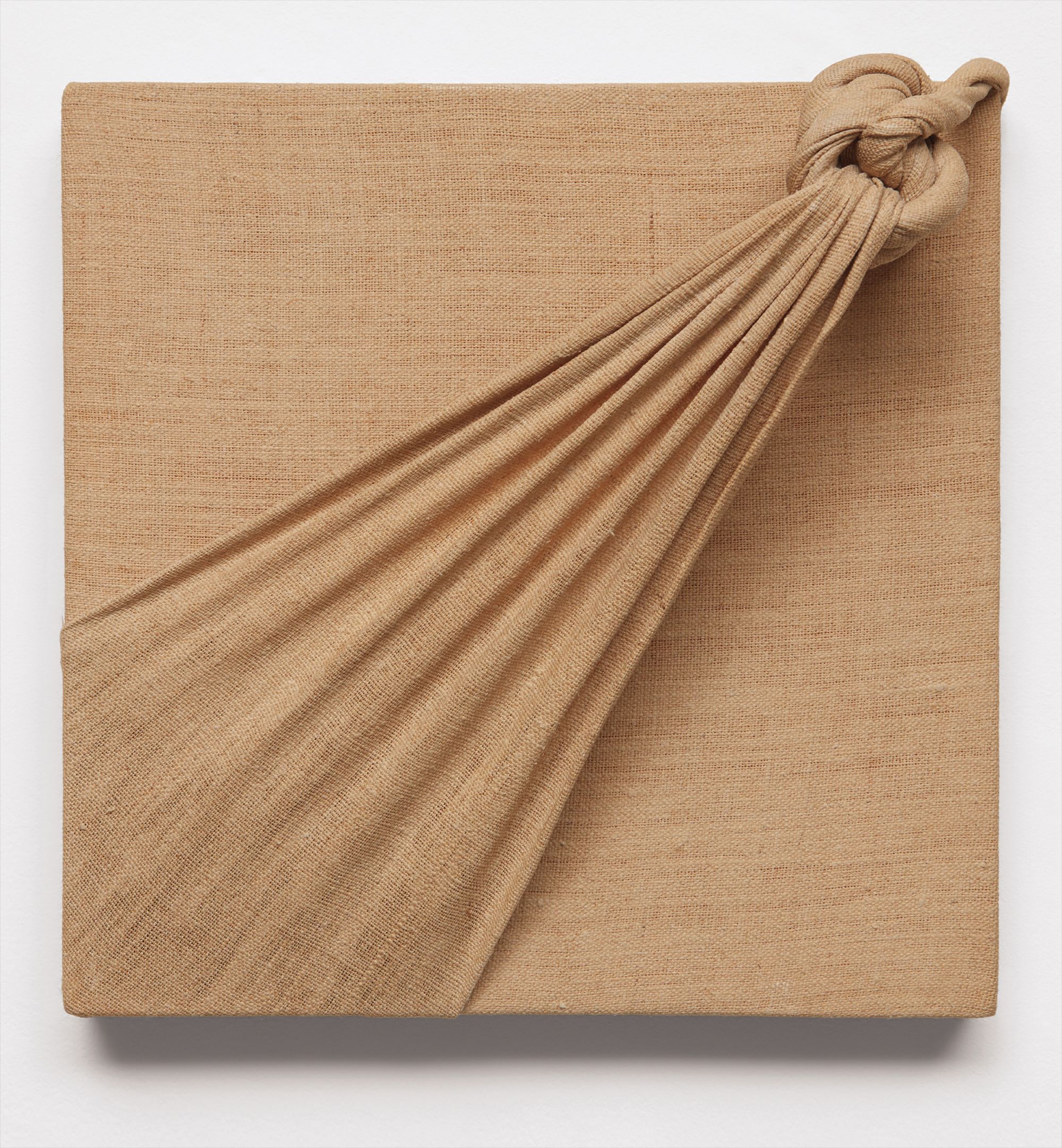 knotted burlap mounted on wood