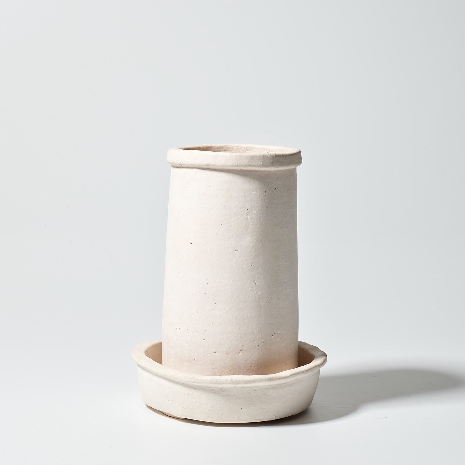 Georgia O'Keeffe — incised with the artist's initials and date "G.o.K. - 83" on the underside of the pot and stand