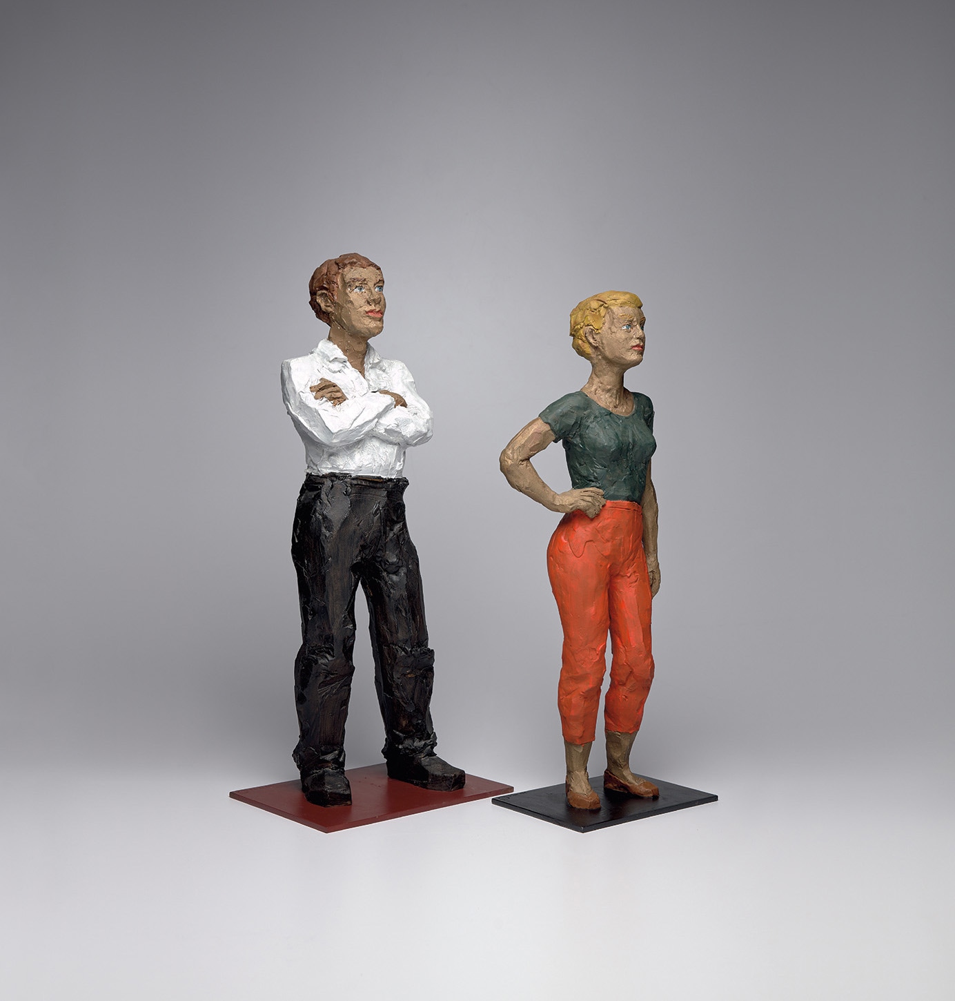 Man in White Shirt; and Woman in Orange Pants with Hand on Hip