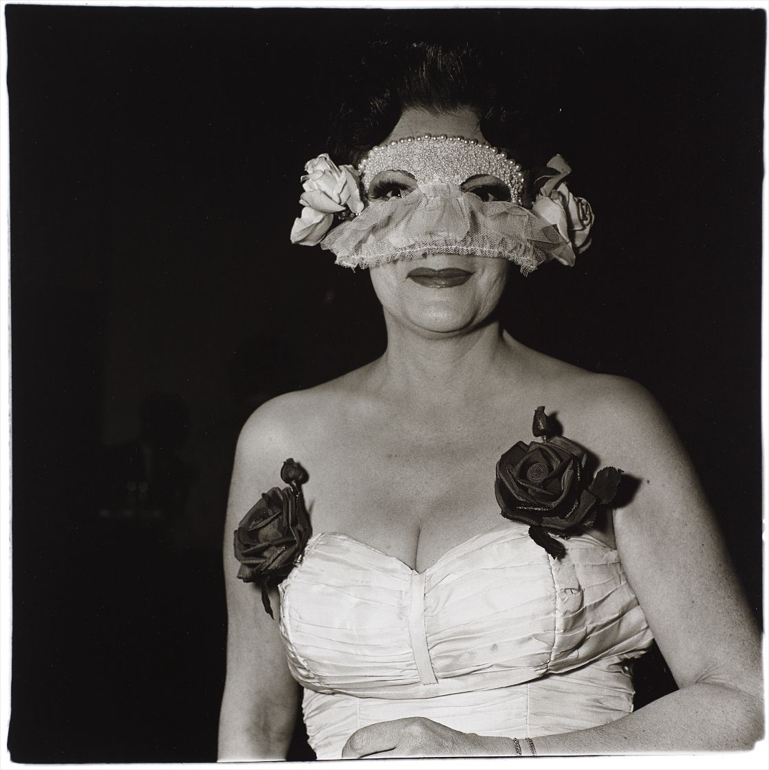 Diane Arbus — Lady at a masked ball with two roses on her dress, N.Y.C.
