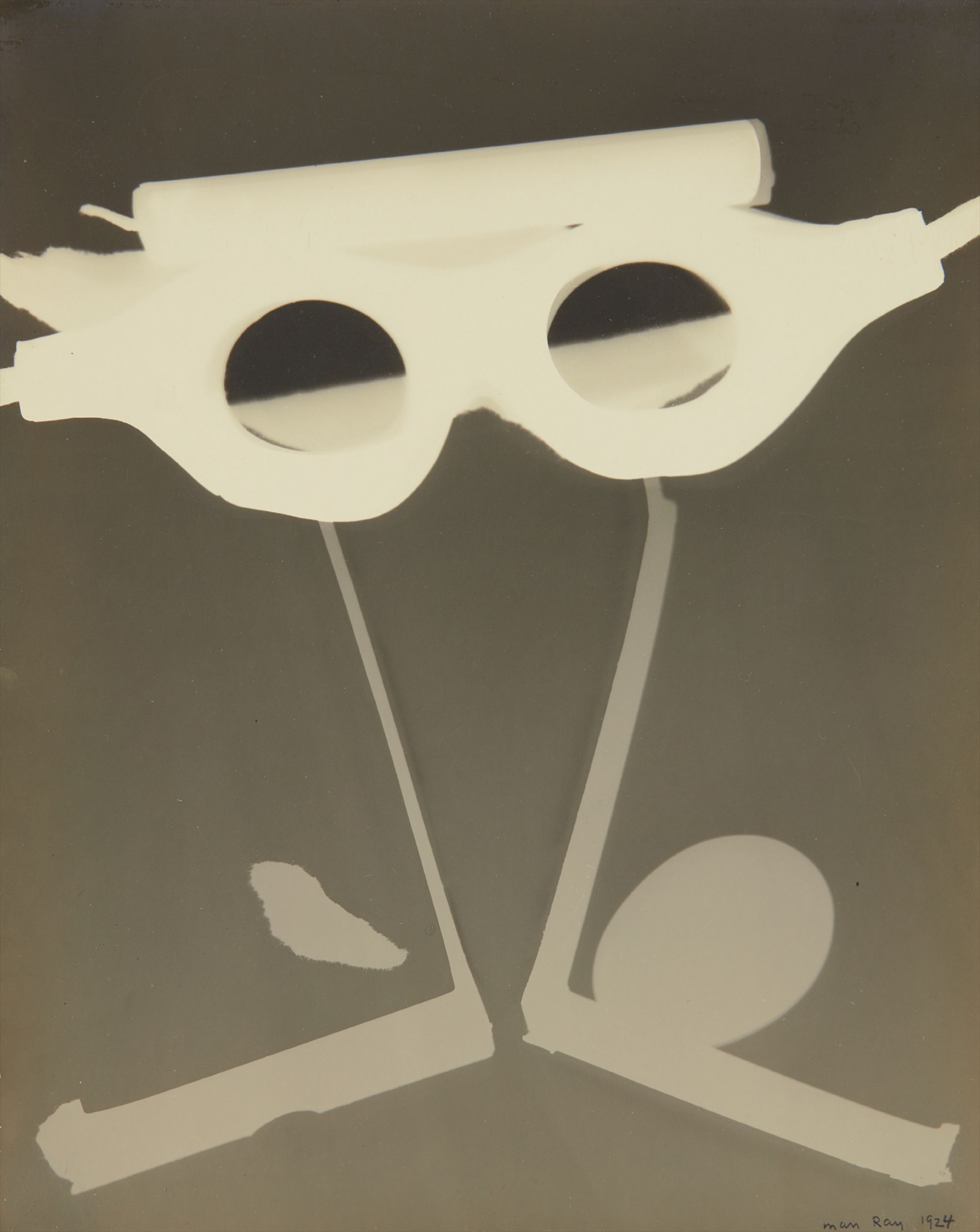 Man Ray — Rayograph with Goggles, Egg and Candle