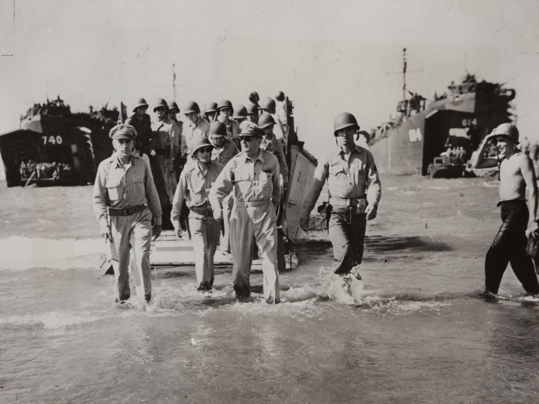 Carl Mydans — Gen. Douglas MacArthur with Gen. Richard Sutherland and Col. Lloyd Lehrbas walks through the surf to the beach at Lingayen, Luzon, the Philippines