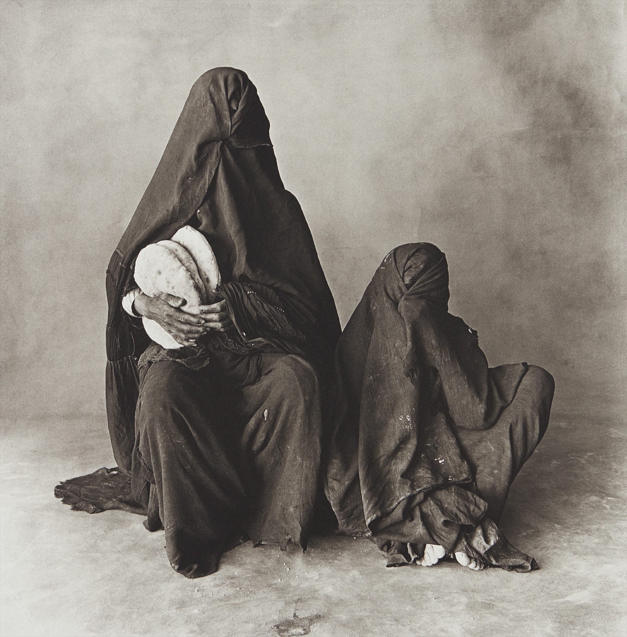 Irving Penn — Two Women in Black with Bread, Morocco