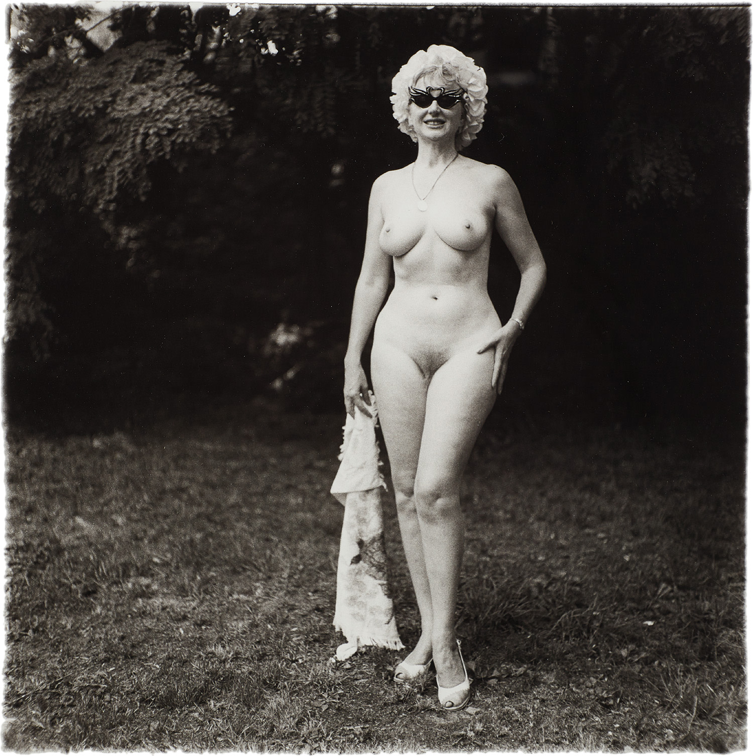 Diane Arbus — Nudist lady with swan sunglasses, Pa.