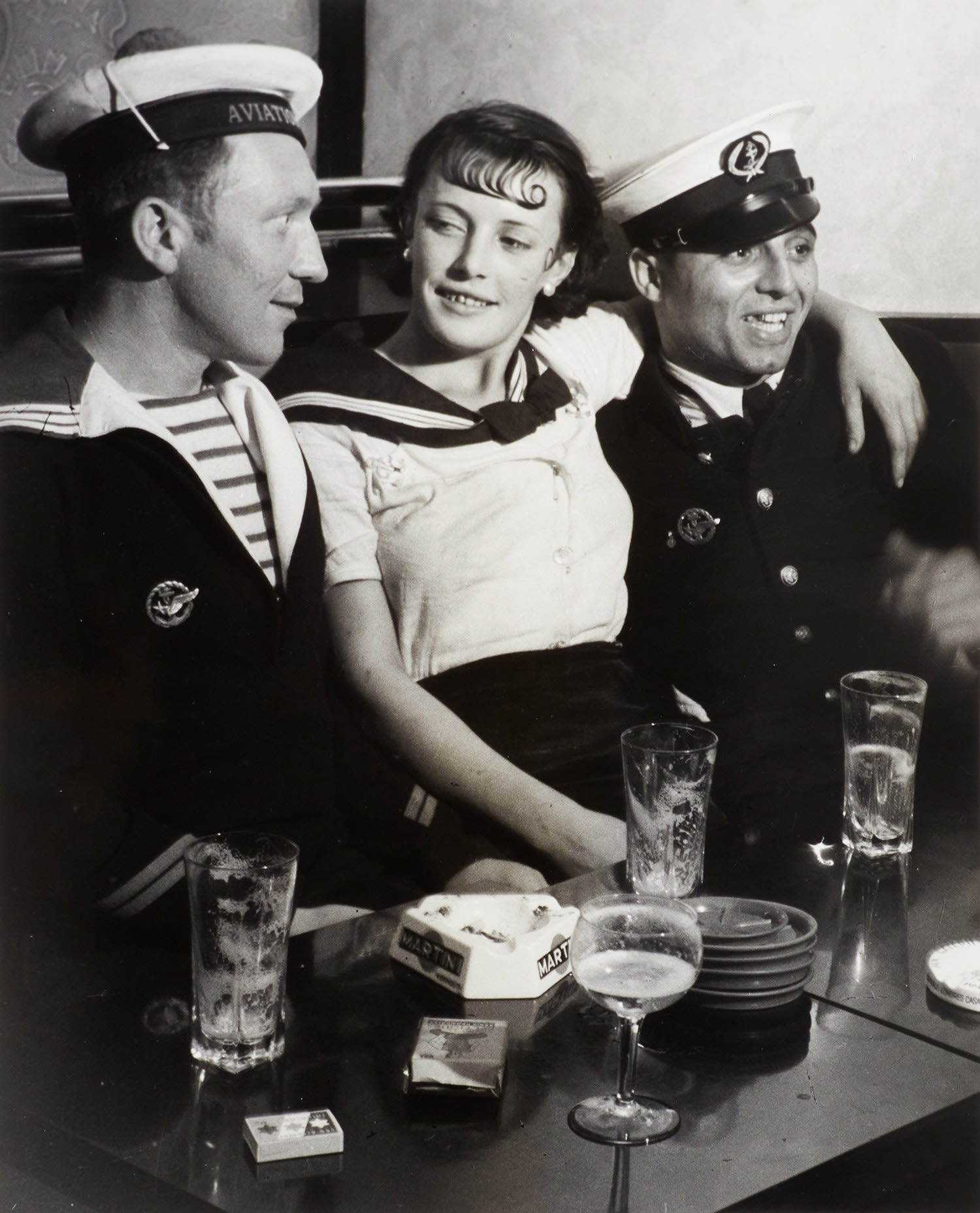 Brassaï (Gyula Halász) — Conchita with sailors in a café on the Place d’Italie