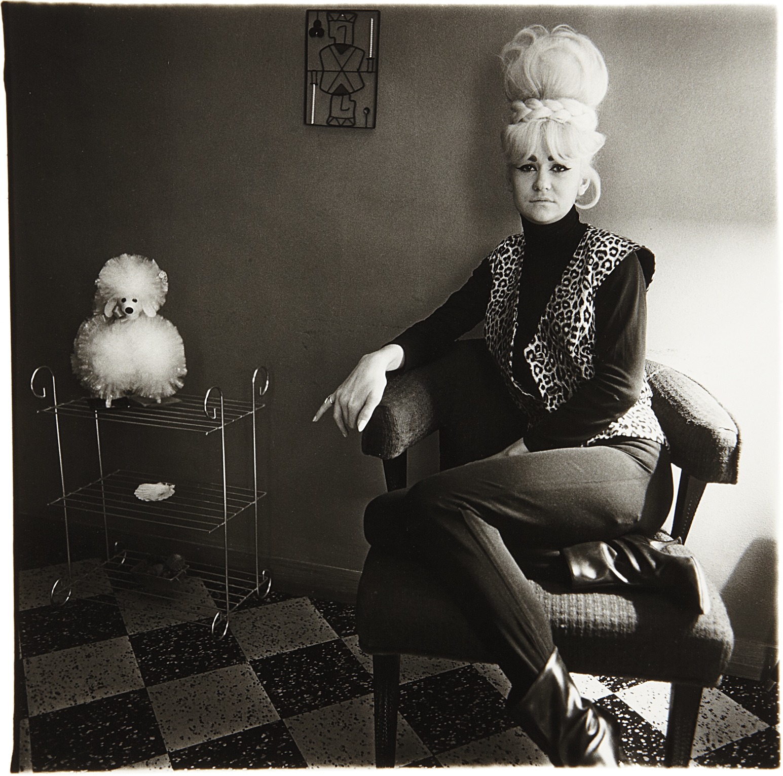 Diane Arbus — Lady bartender at home with a souvenir dog, New Orleans