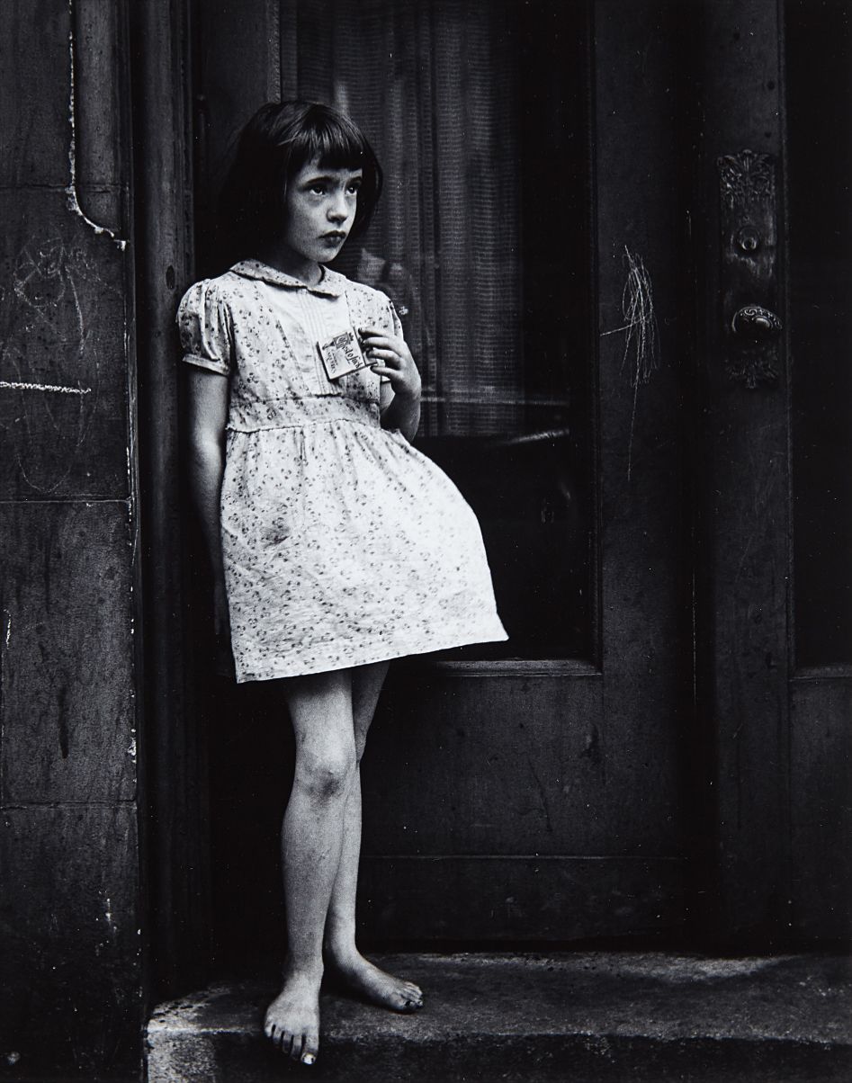Yasuhiro Ishimoto — Young Girl, Barefoot, Holding Package of Candy Cigarettes