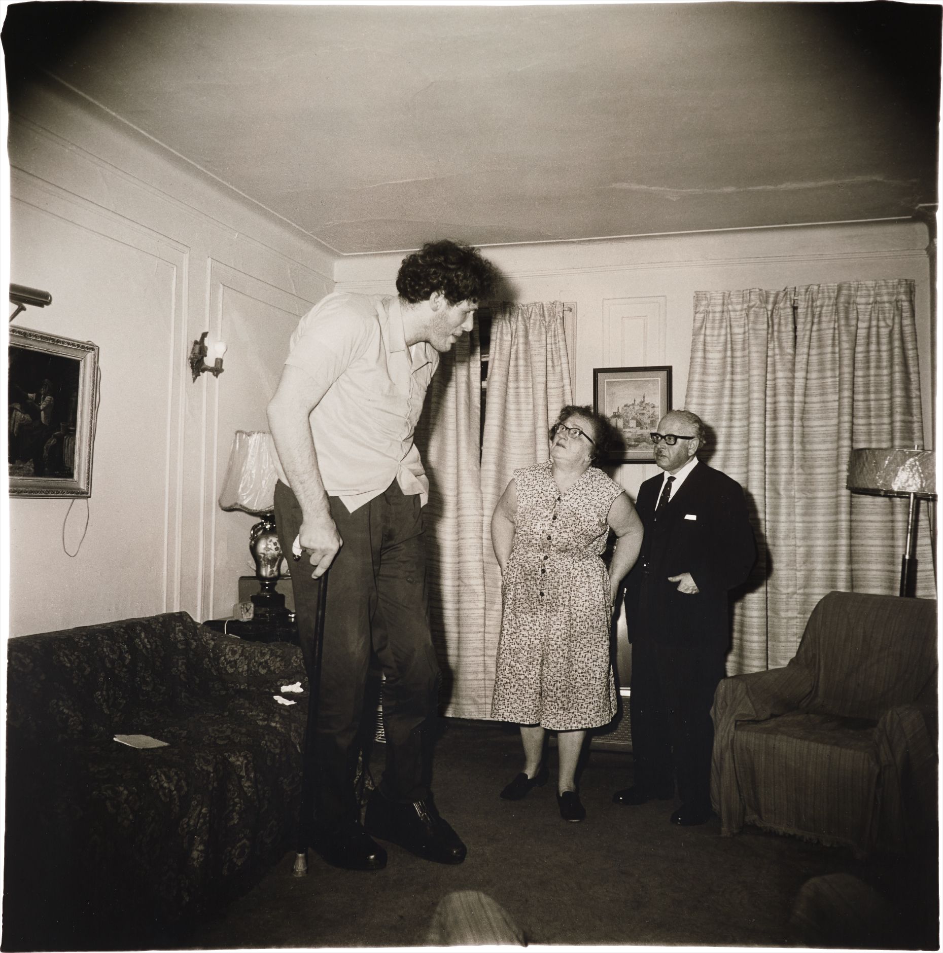 Diane Arbus — A Jewish giant at home with his parents in the Bronx, N.Y.