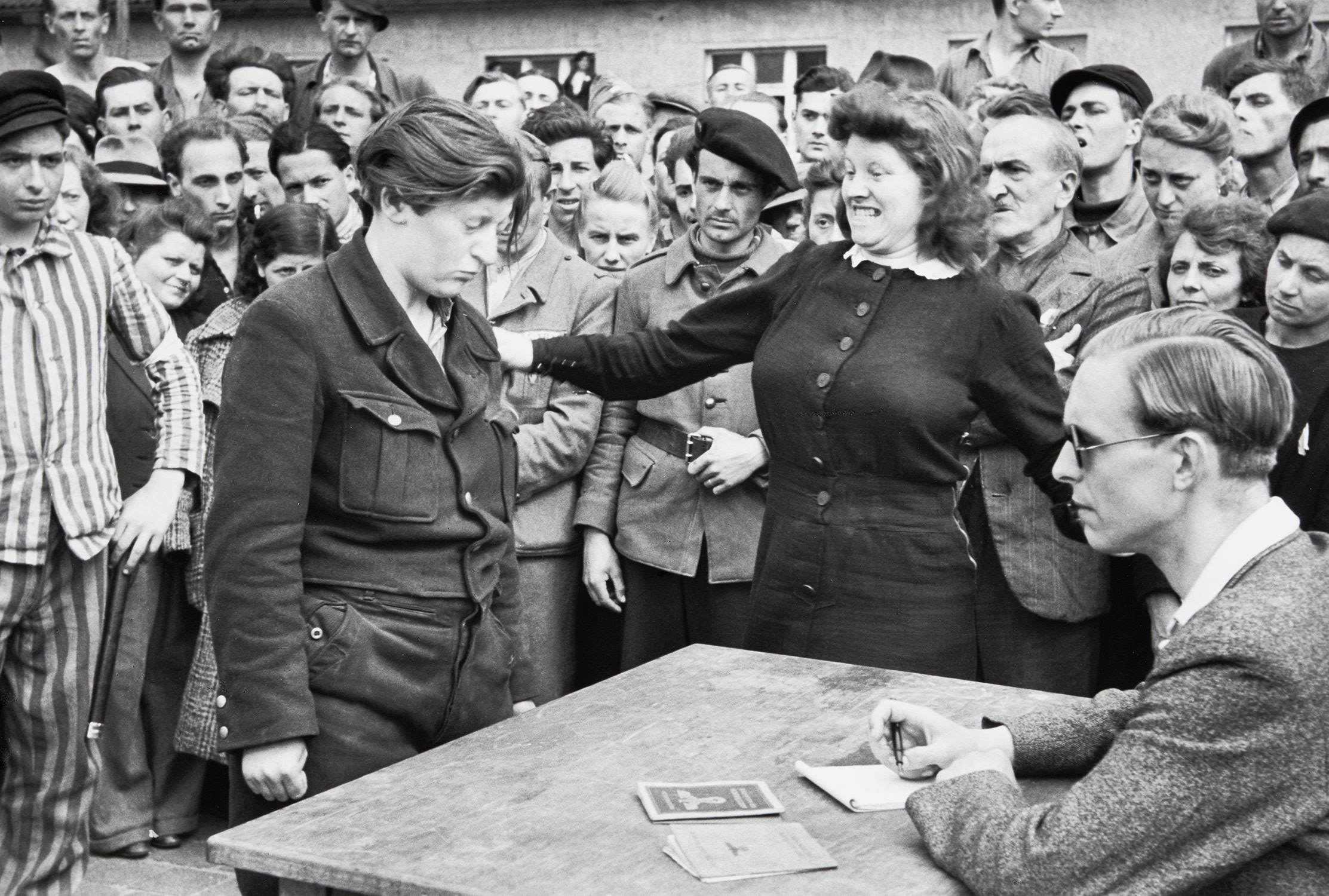 Henri Cartier-Bresson — Gestapo informer recognized by a woman she had denounced, Transit Camp, Dessau